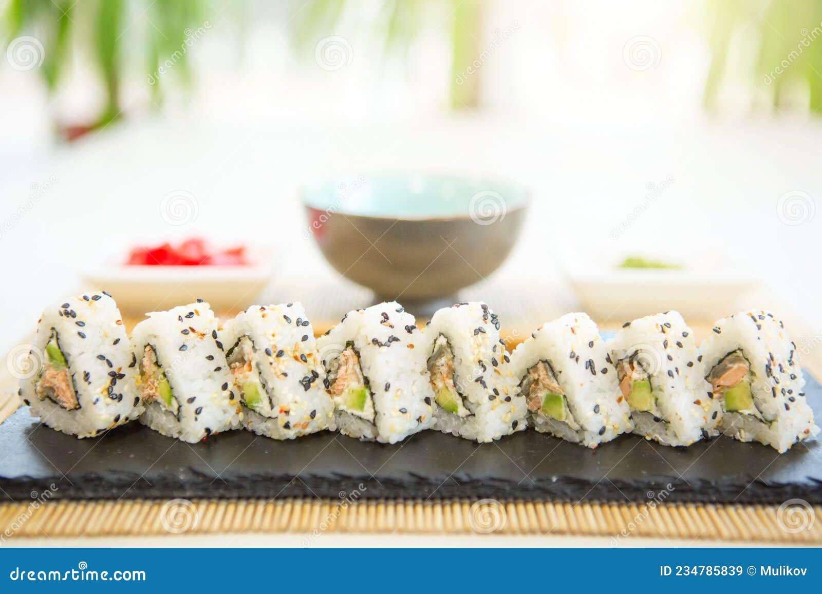 homemade sushi with salmon, omelet, cucumber and soft cheese. rustic style