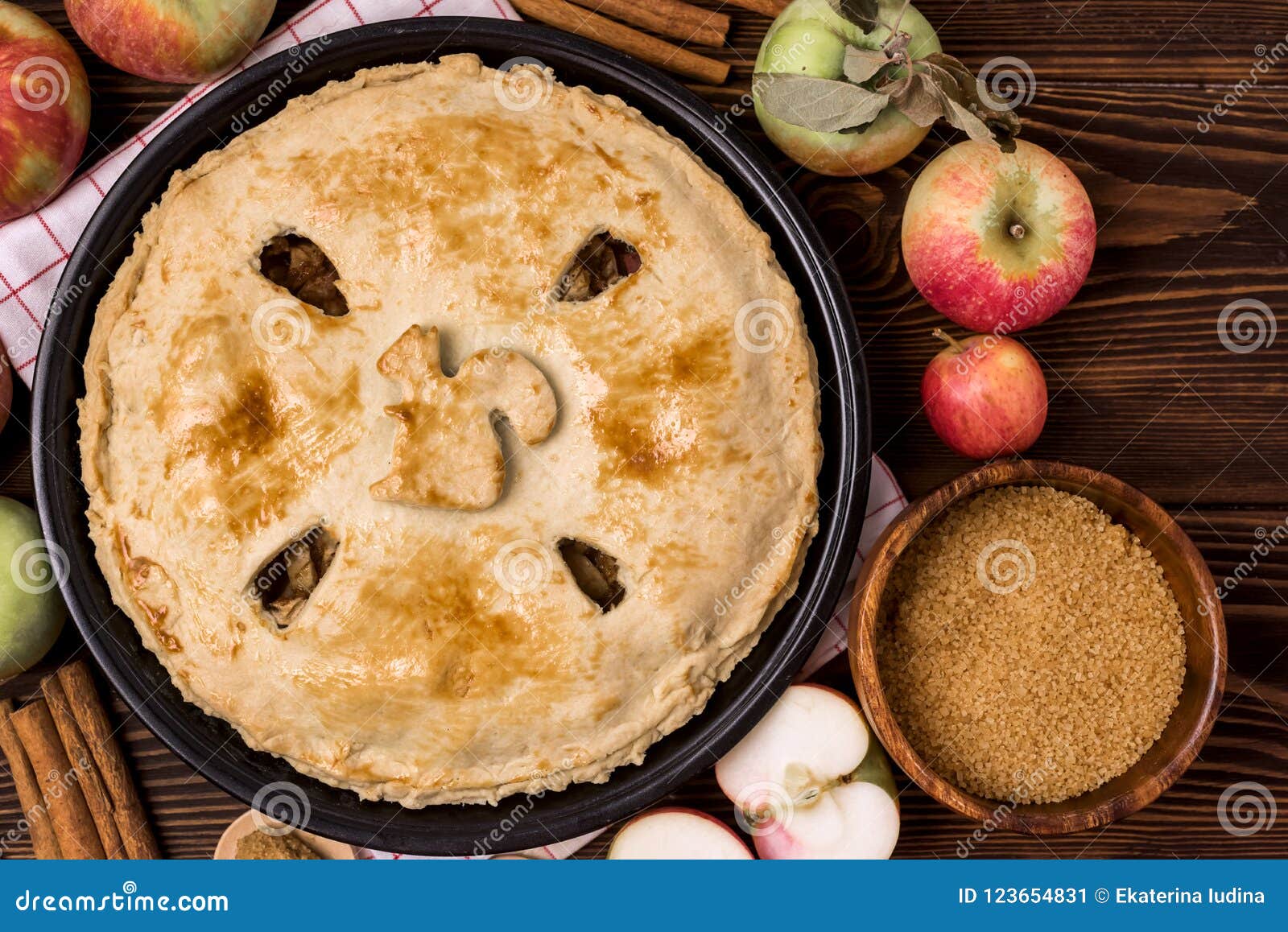 homemade tasty apple pie with apples and spices wooden background top view raw apples cinnamone sticks copy space