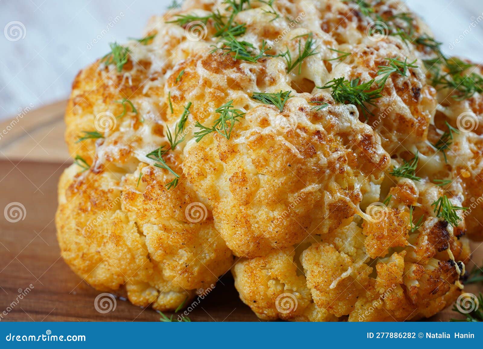 Homemade Whole Roasted Cauliflower with Cheese and Herbs Stock Photo