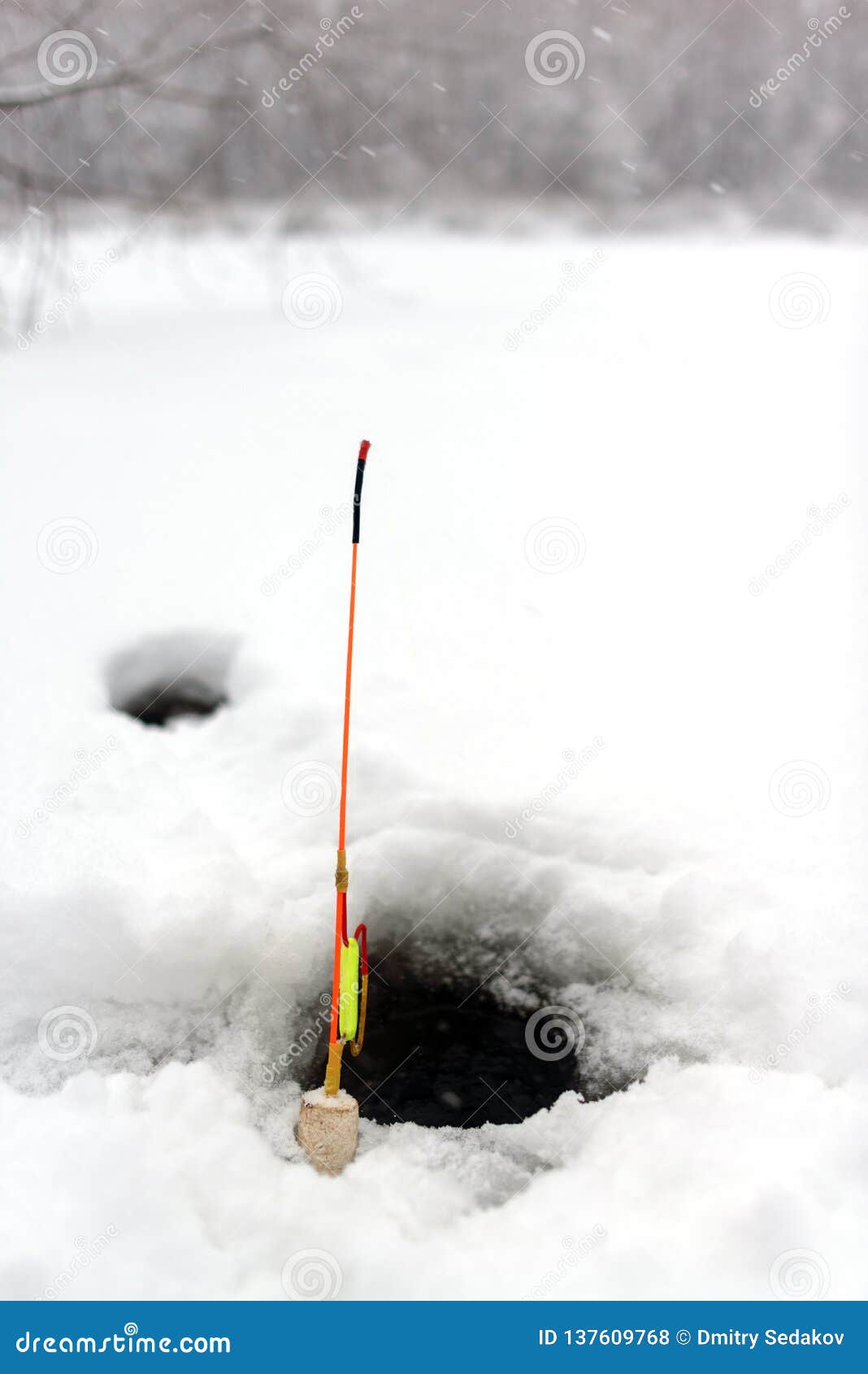 Homemade Winter Fishing Rod Stands at the Hole in the Ice of the