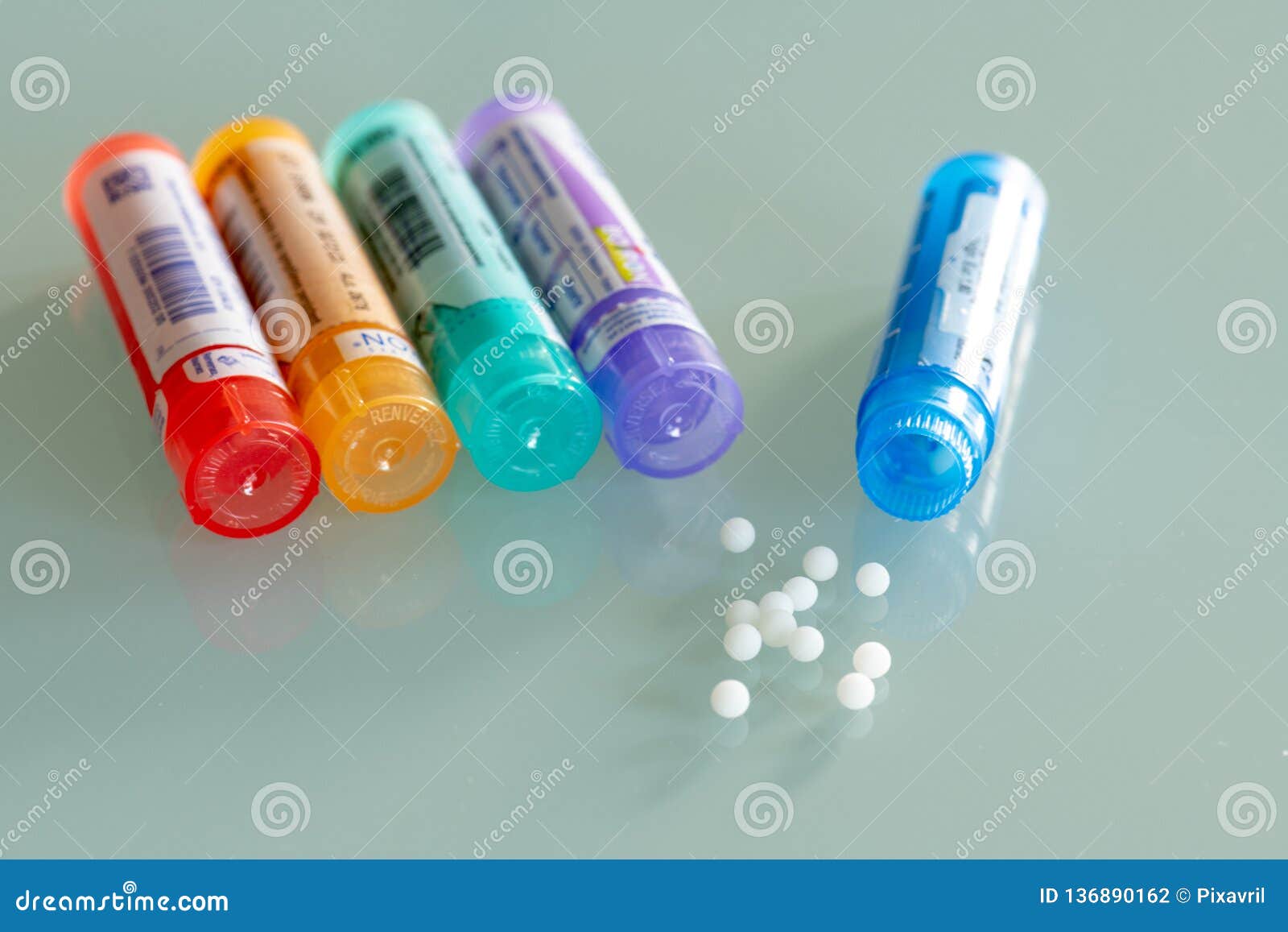 homeopathic globules scattered around with their colored containers