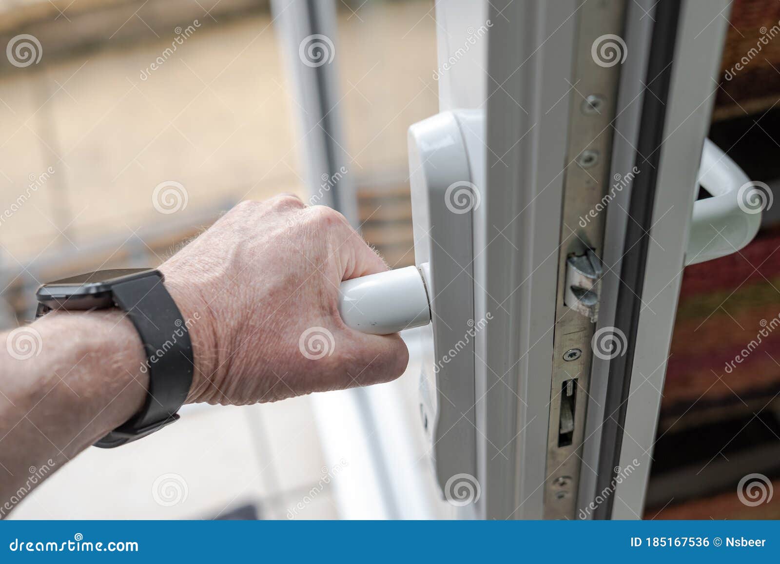 homeowner seen gripping the handle of a newly installed upvc high security door.