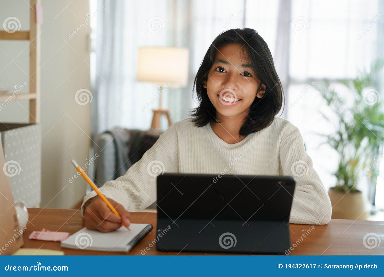 Homeschooling Asian Girl Doing Homework And Study Online With Table