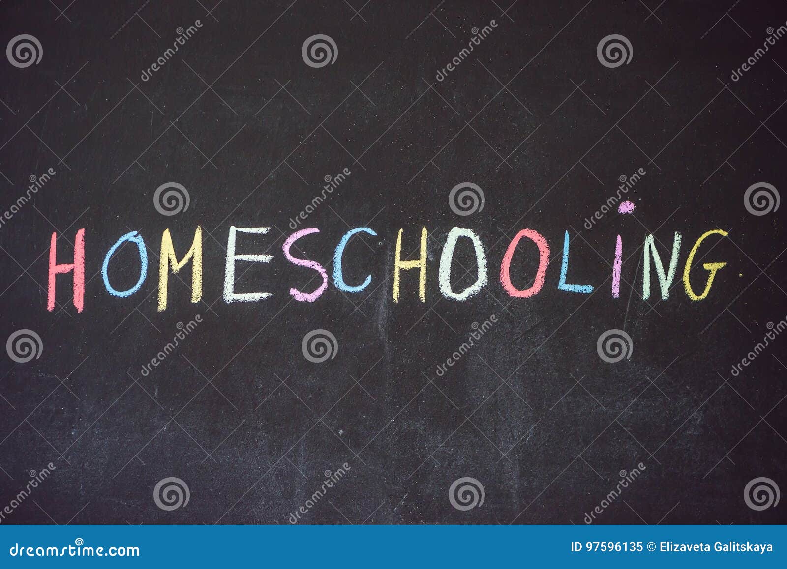 homeschooling. child pointing at word homeschooling on a blackboard