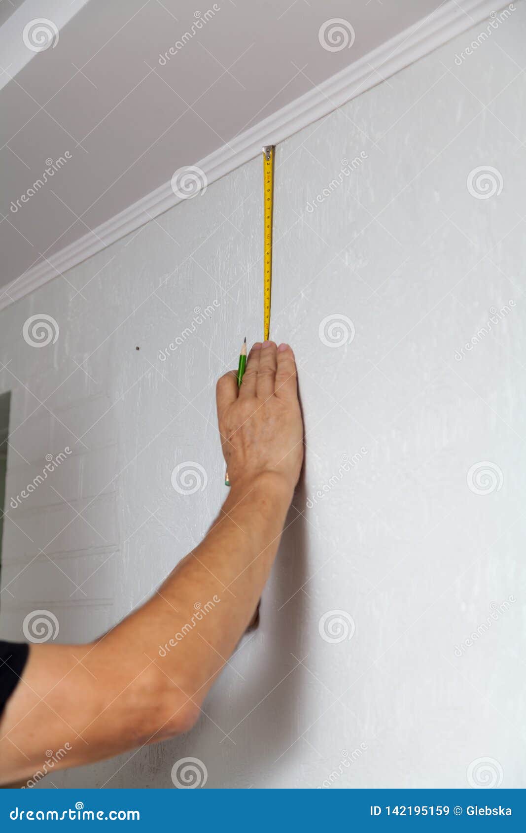 Hands Make Wall Marking With Tape Measure And Pencil Stock