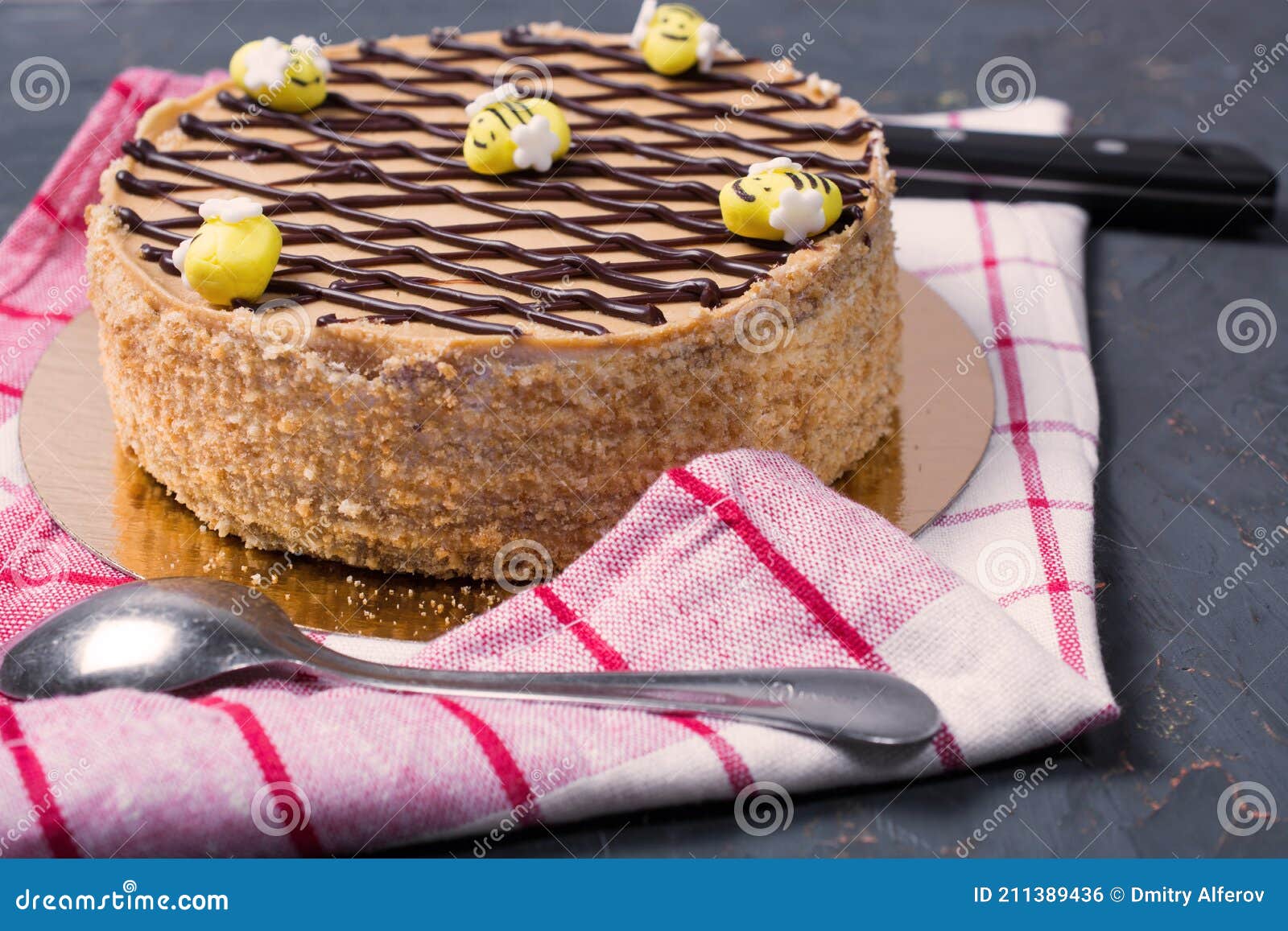 Honey Cake with Edible Bees on Top on a Checkered Red Towel