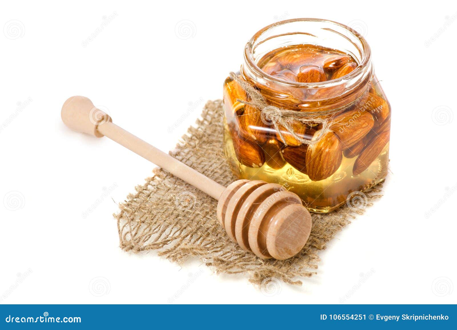 A Honey Jar with a Spoon for Honey Nuts Almonds Stock Image - Image of  background, drop: 106554251