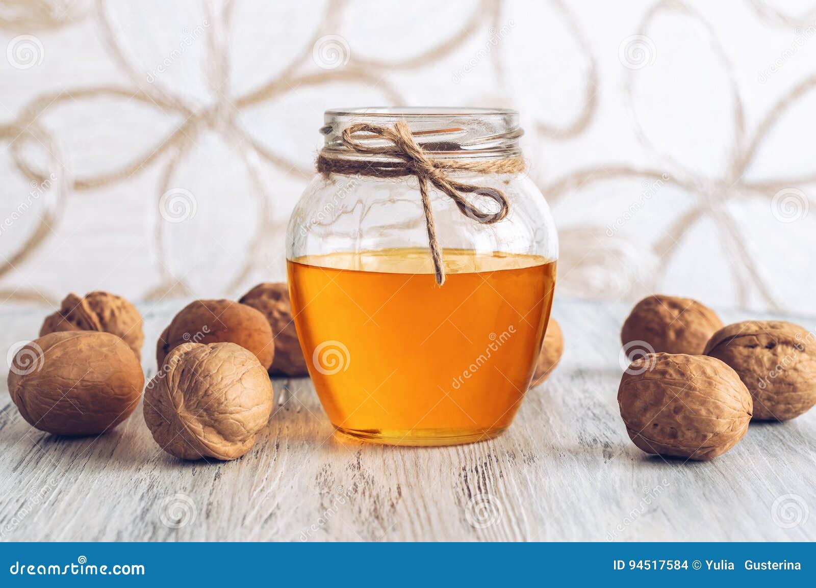 Honey and Walnuts. Honey with Nuts on Wooden White Table. Beautiful