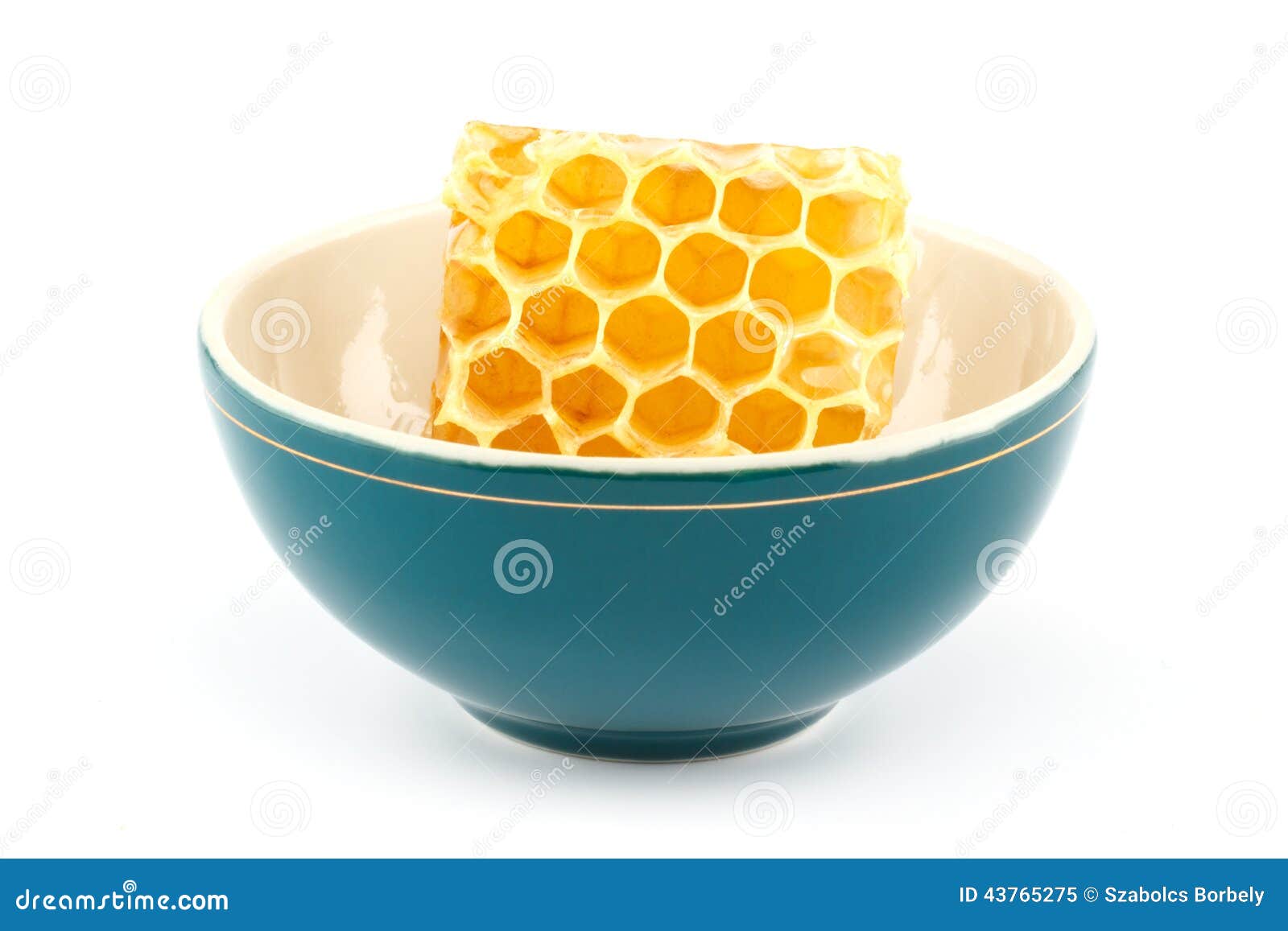 Honeycomb in bowl. Honeycomb in green porcelain bowl on white isolated background