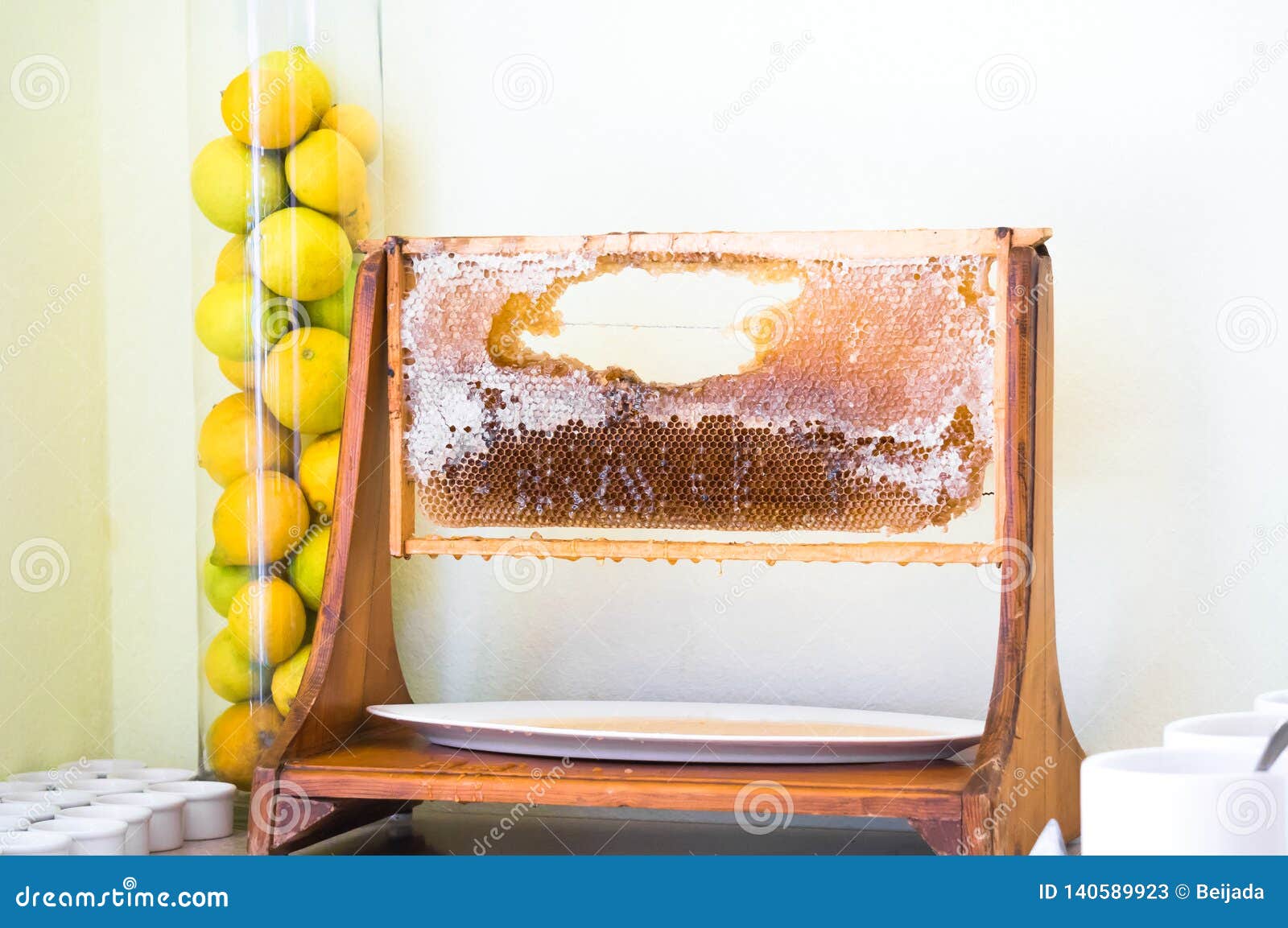 Honeycomb Display Frame in Restaurant and Lemons Aside in Glass Tube