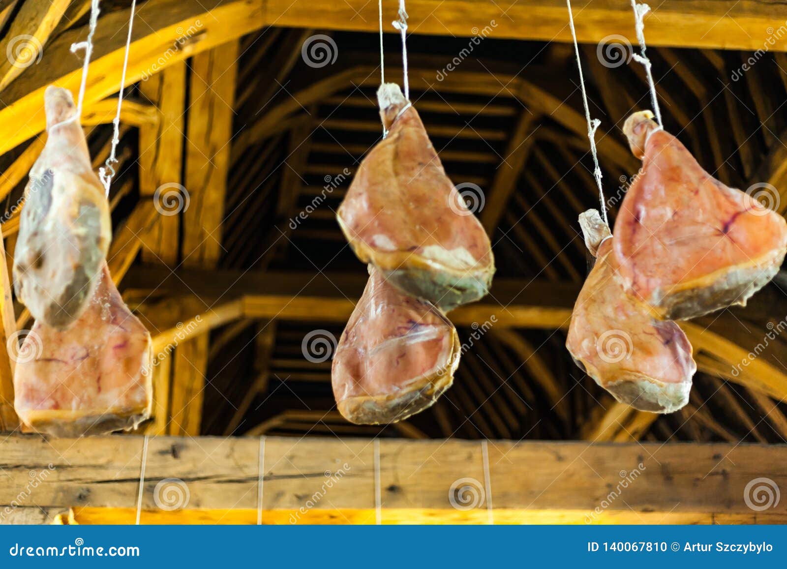 Hooked Ham On Wooden Beams That Hang From The Ceiling Traditional
