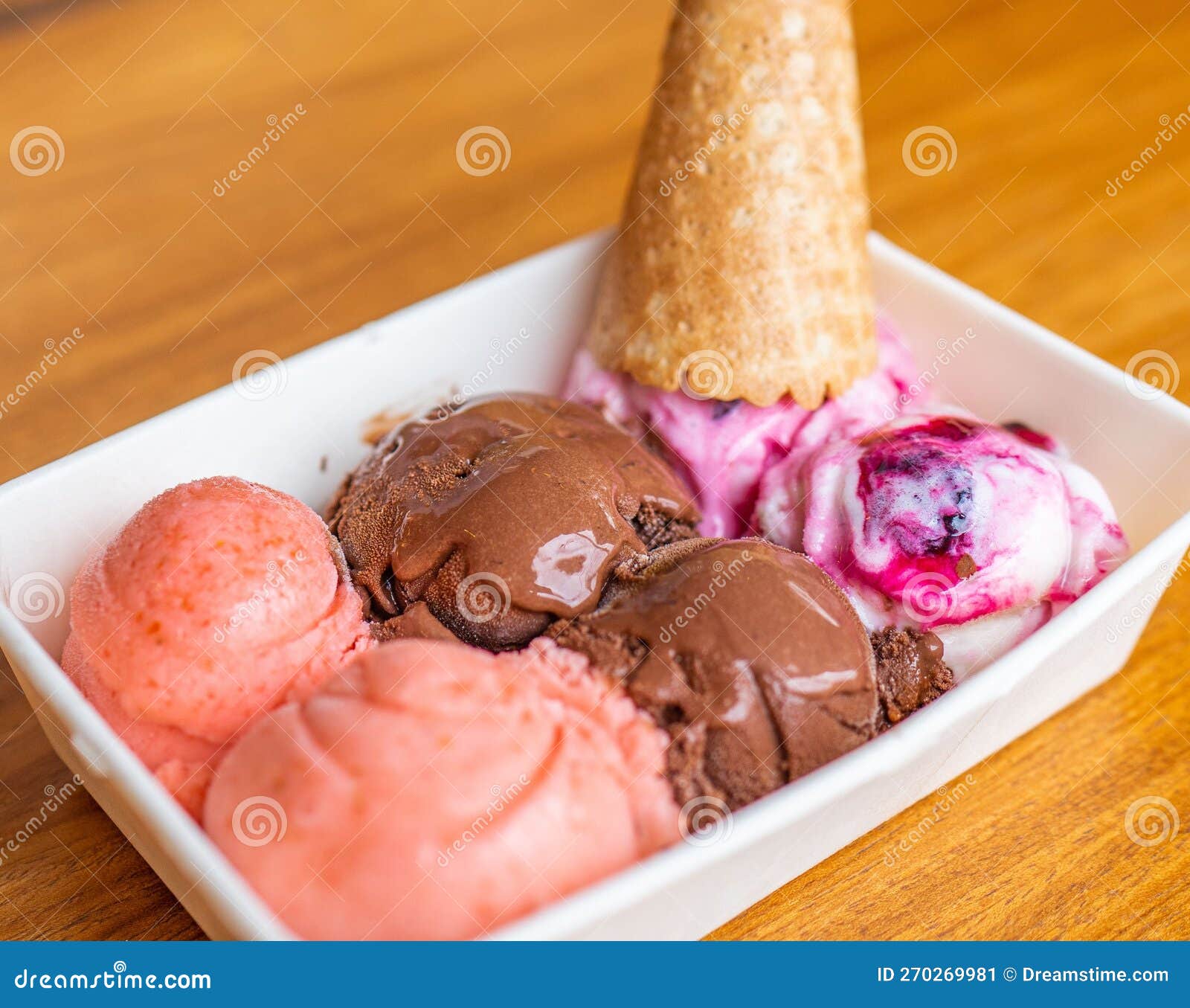 horizontal photo of delicious and creamy chocolate ice cream, strawberry and blackberry with a cono