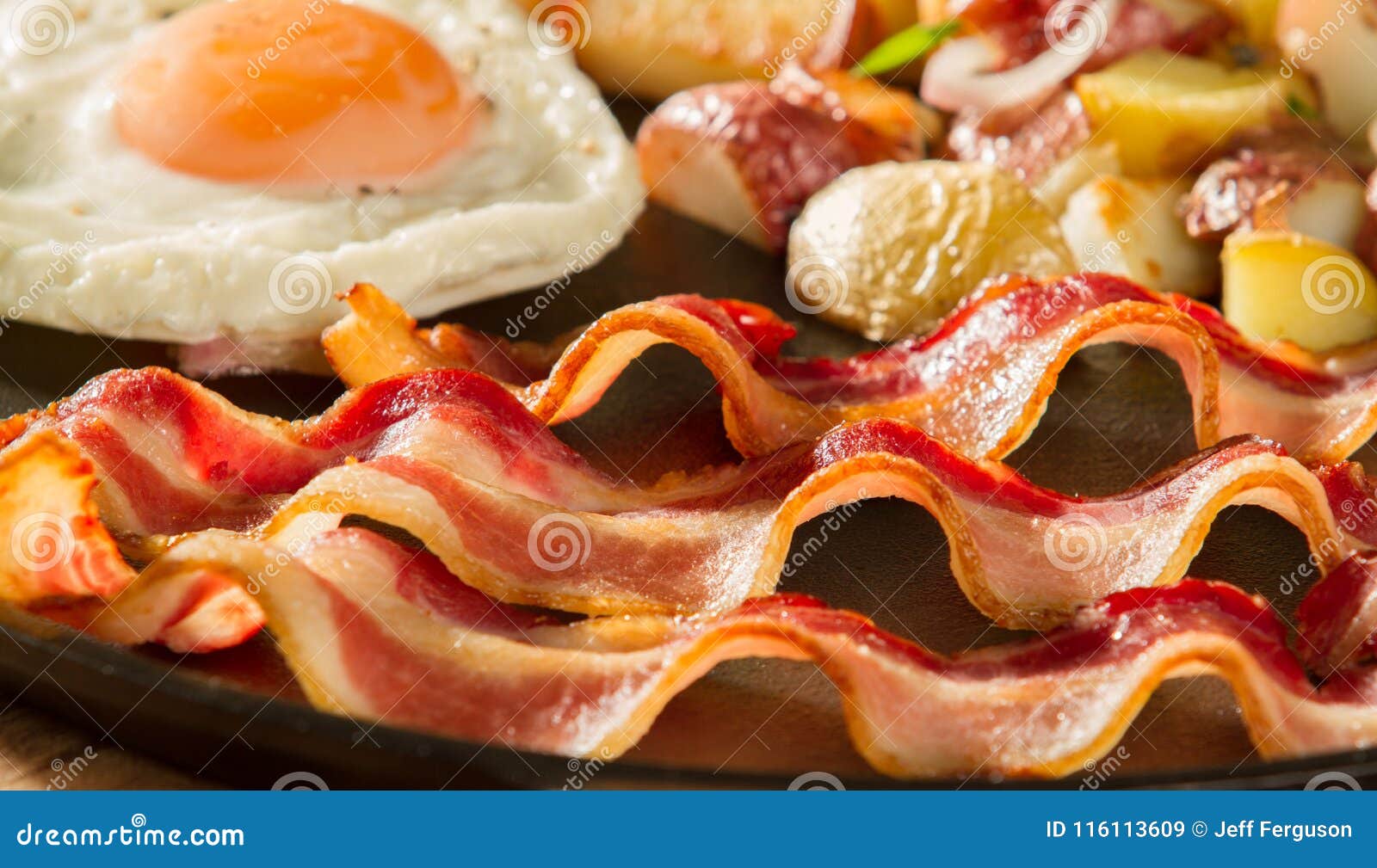 Eggs and Bacon with Potatoes Stock Image - Image of board, cooking