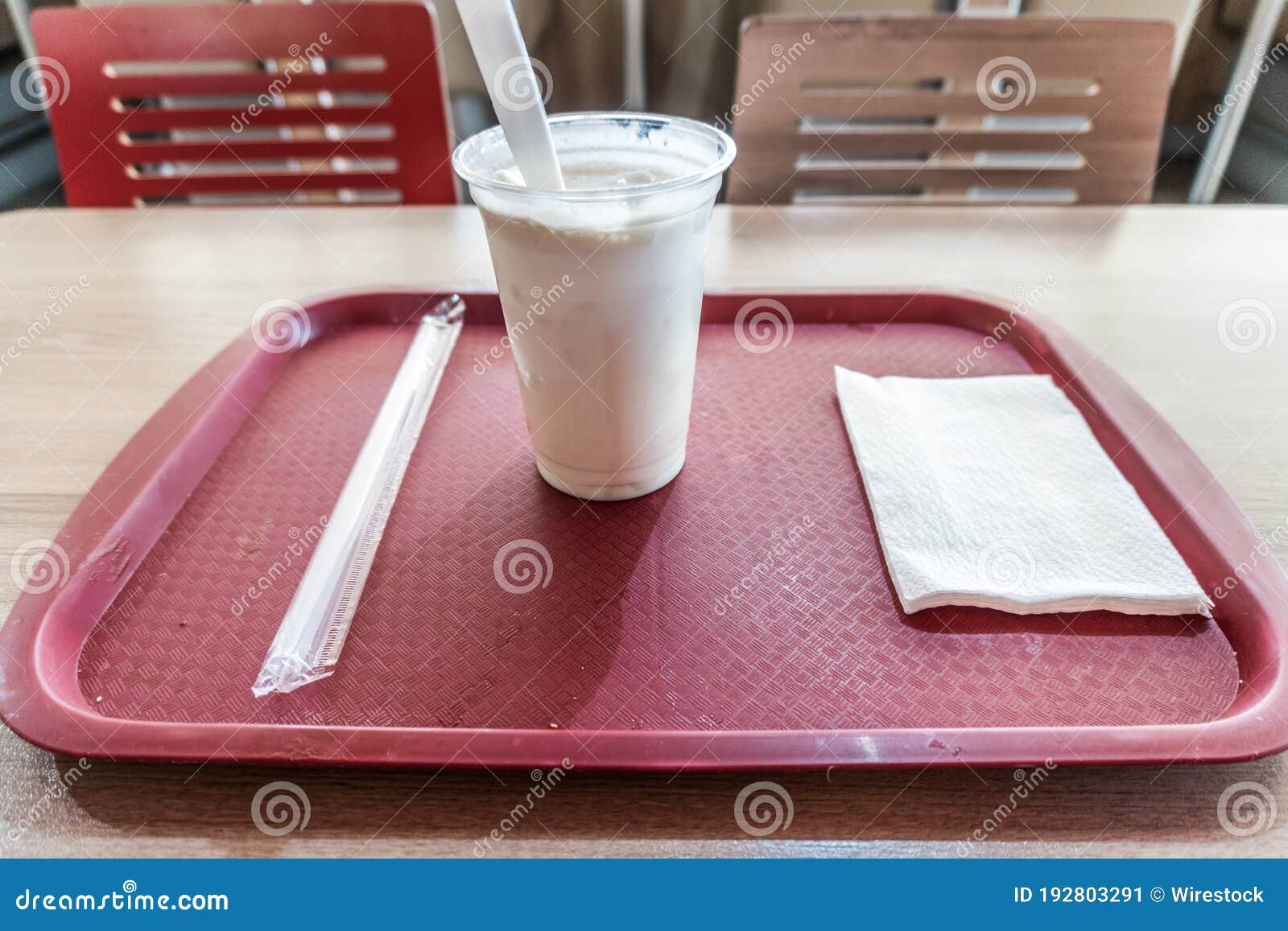 Horizontal Shot of a Hot Coffee in a Plastic Cup Served on a Red Tray