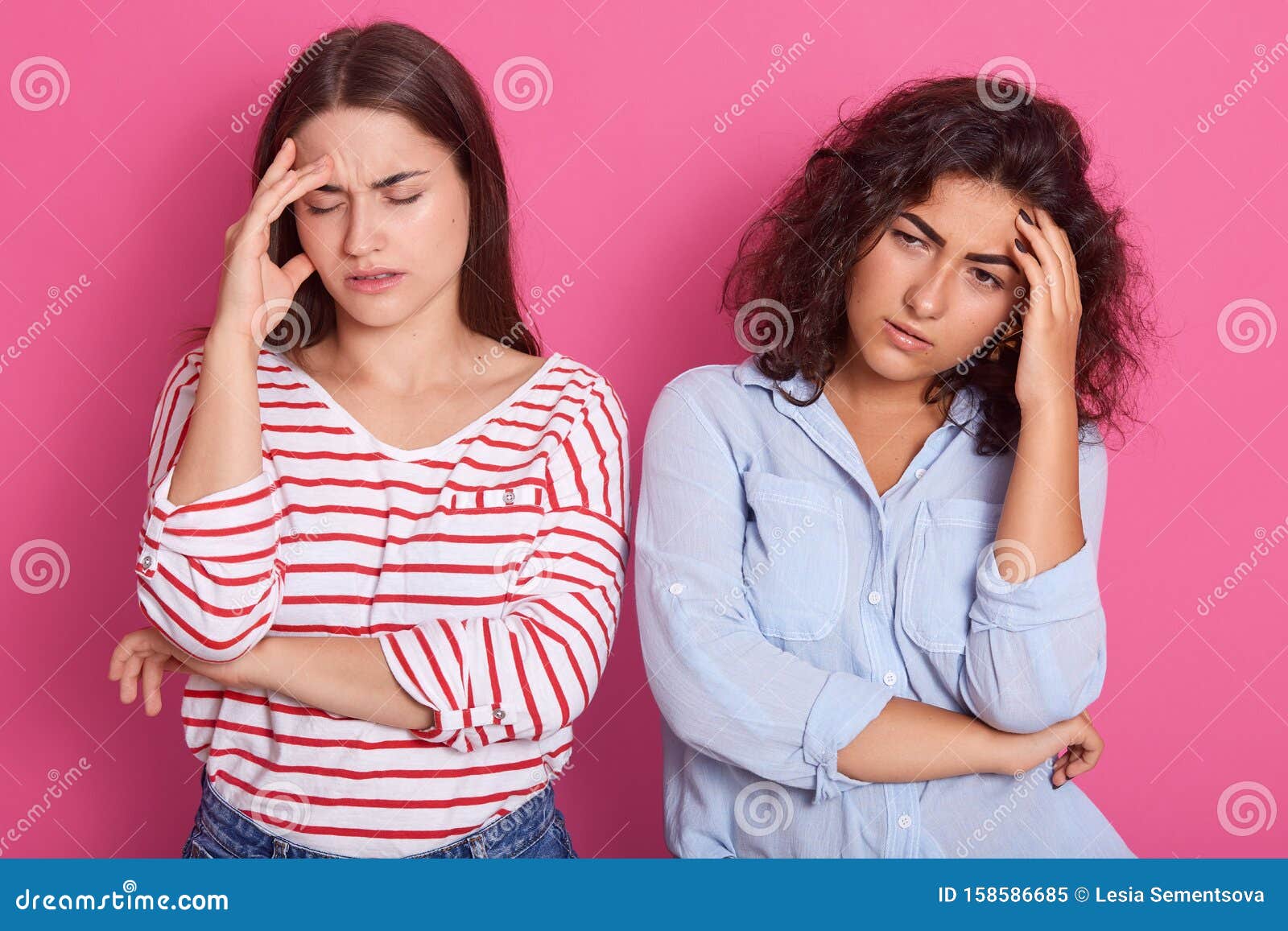 Horizontal Shotof Two Women Standing and Keeping Hands on Forehead ...