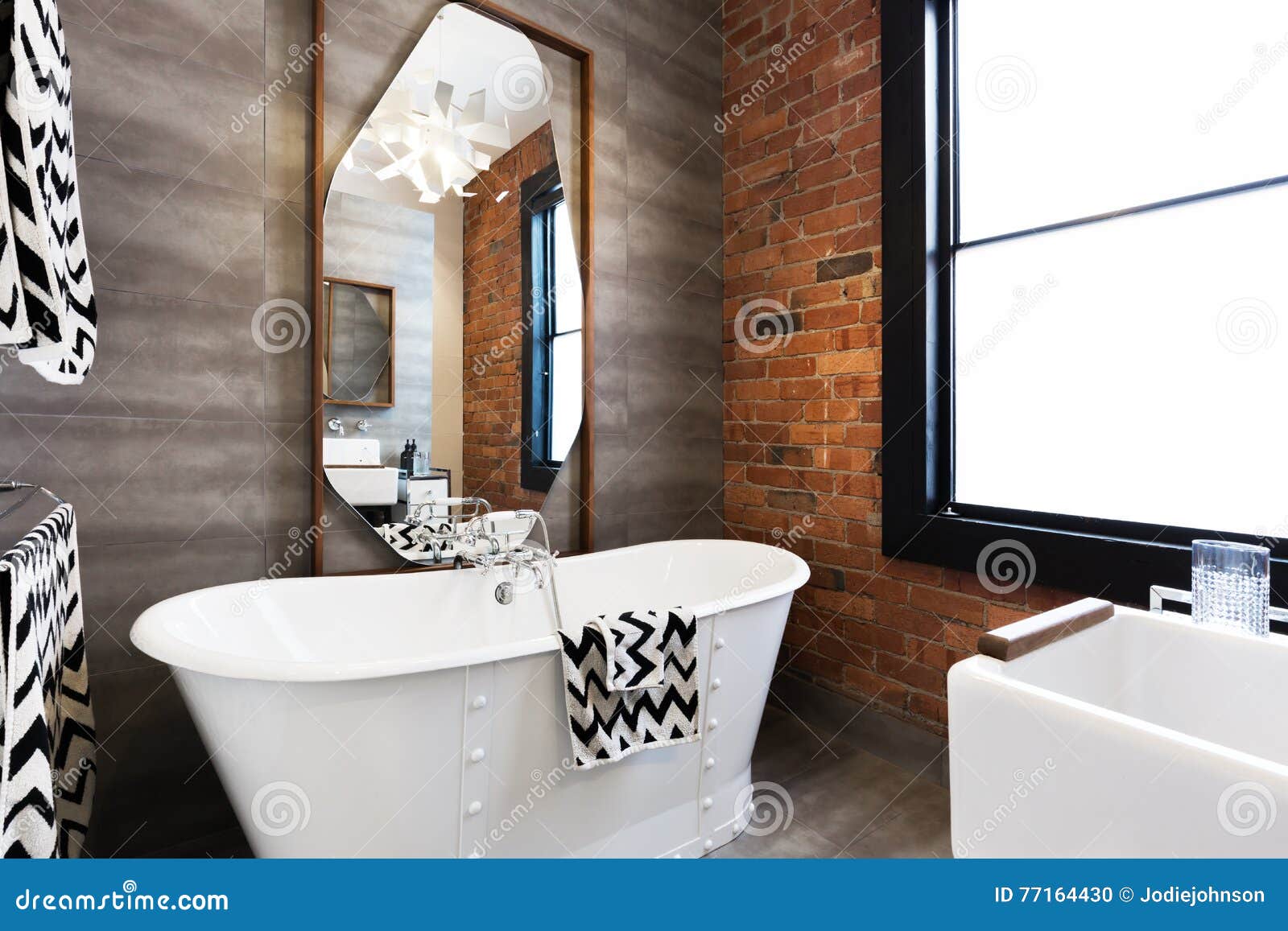 horizontal version freestanding vintage style bath tub in renovated warehouse apartment