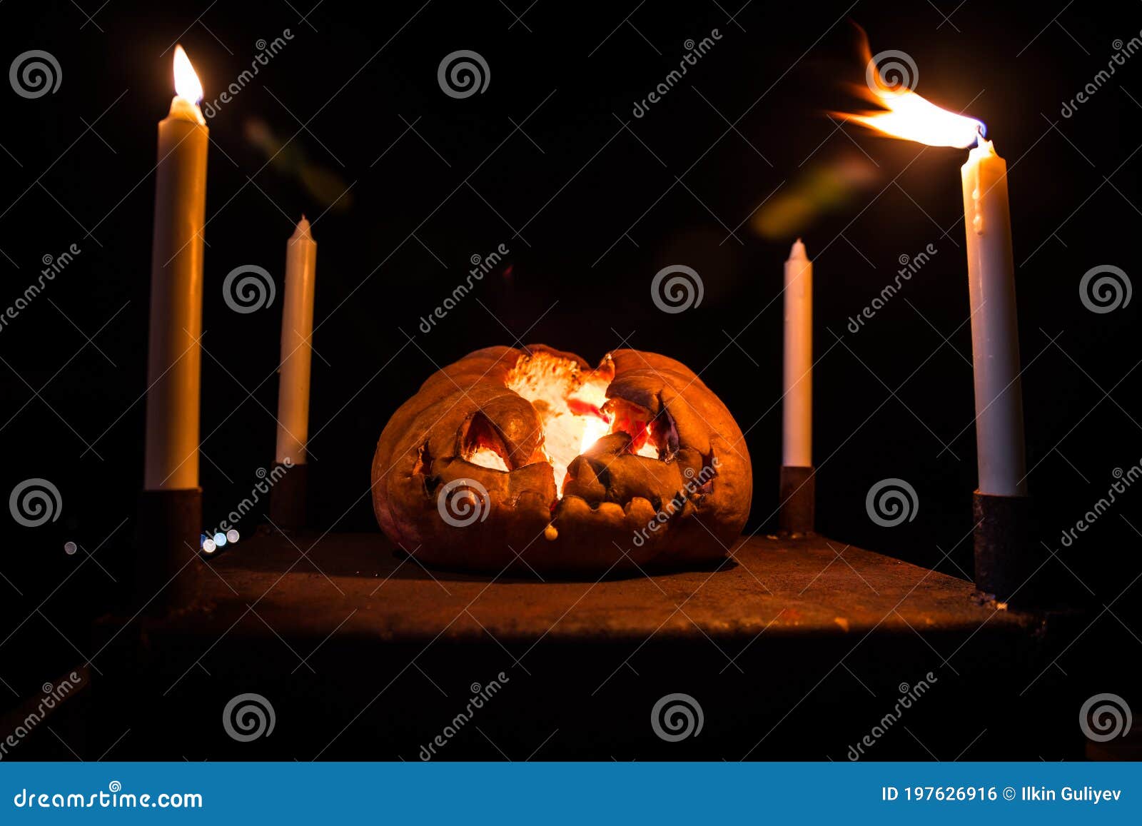 horror halloween concept. close up view of scary dead halloween pumpkin glowing at dark background. rotten pumpkin head