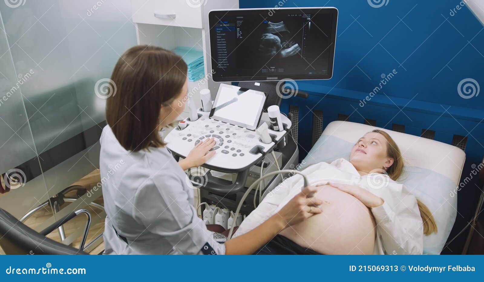 In The Hospital Obstetrician Uses Transducer For Ultrasound Sonogram Screening Scanning Belly 