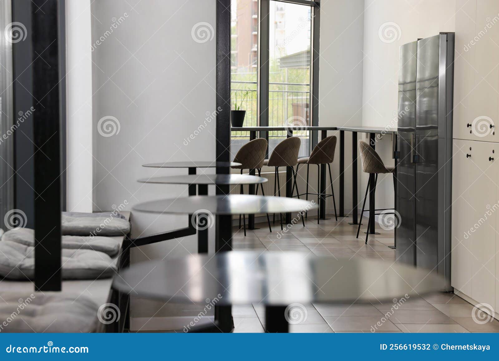 Hostel Dining Room Interior with Modern Furniture and Refrigerators