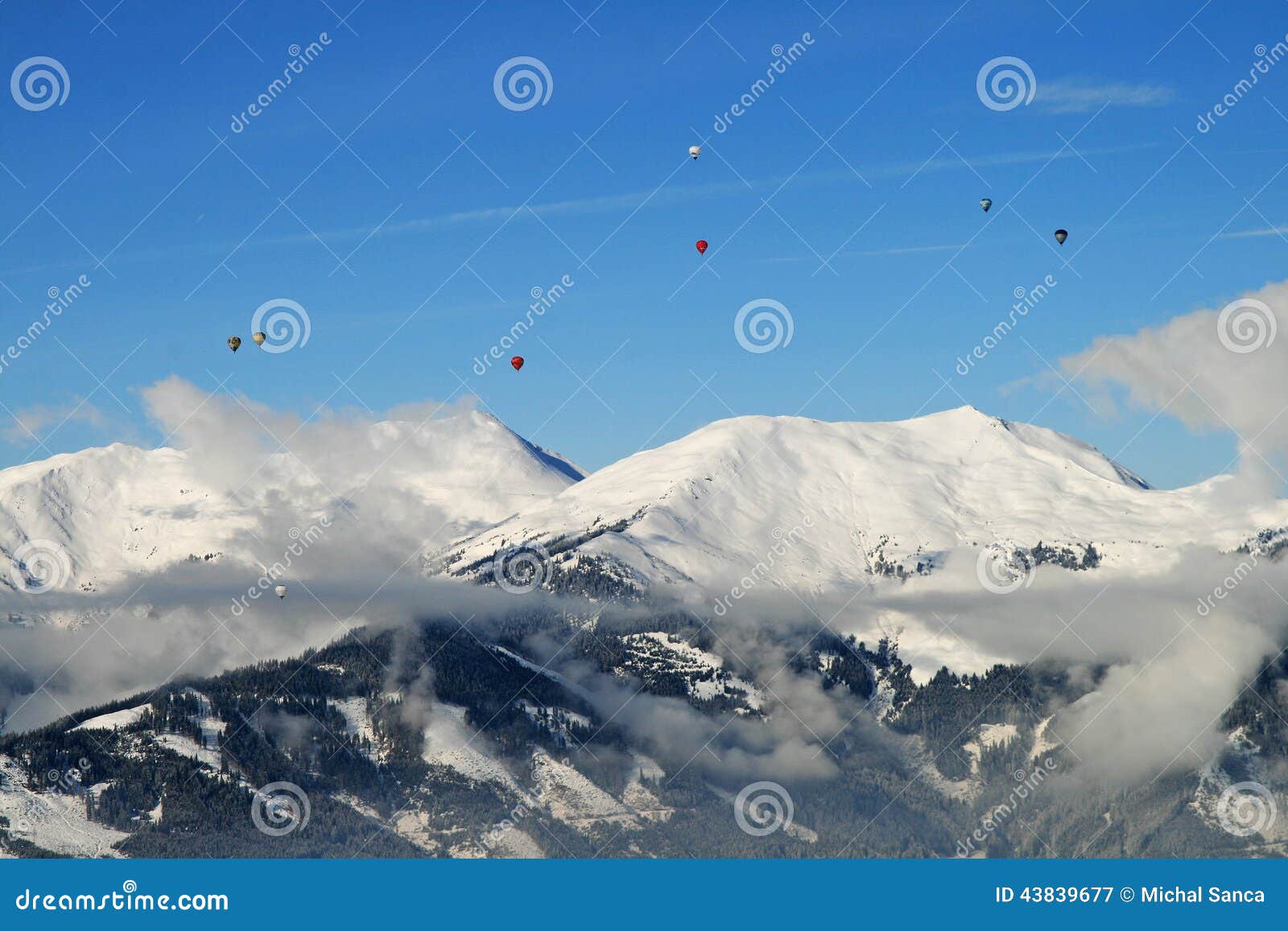 hot air ballooning over the tops of mountains