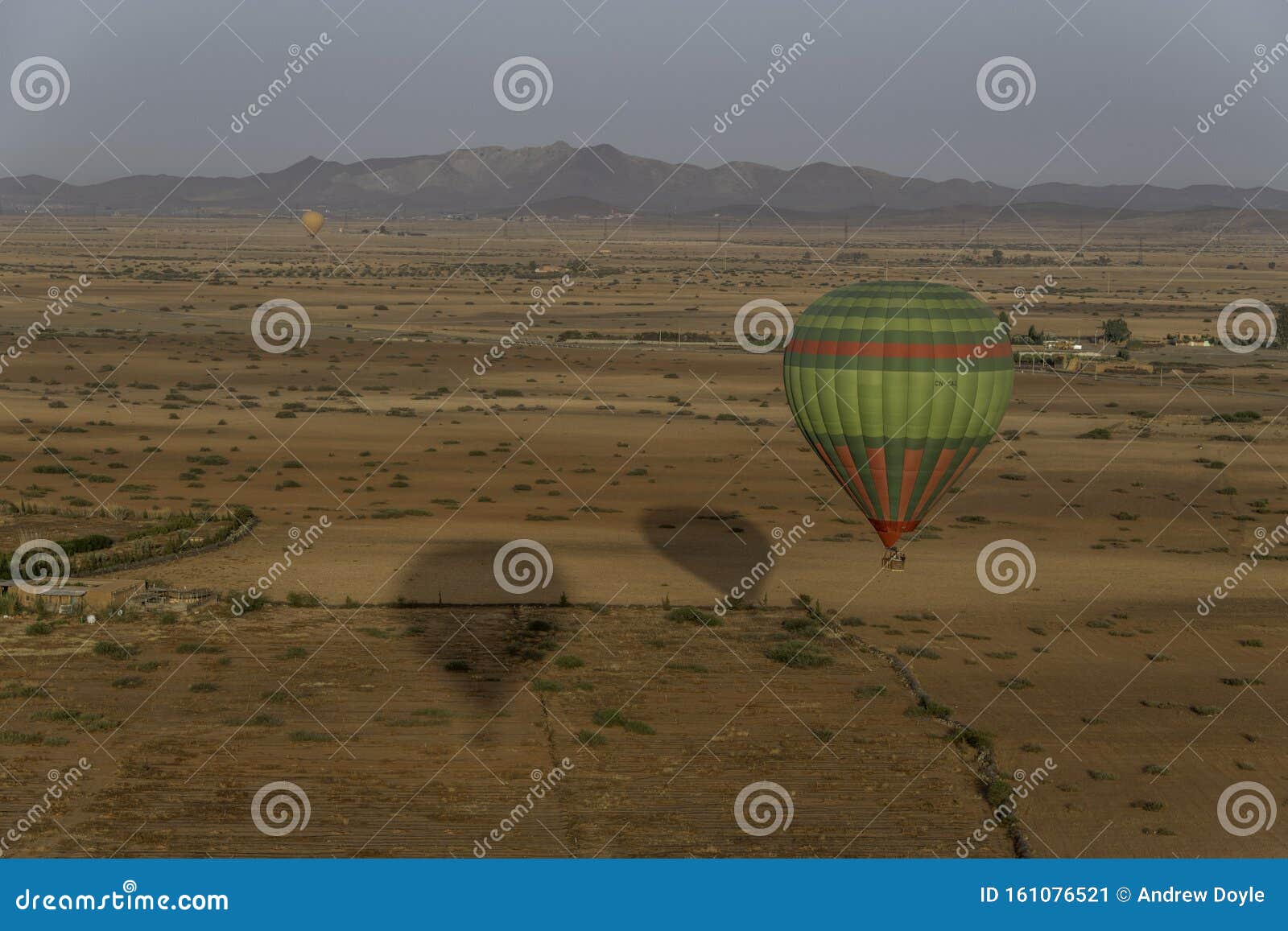 hot air balloons over desert pastureland of morocco