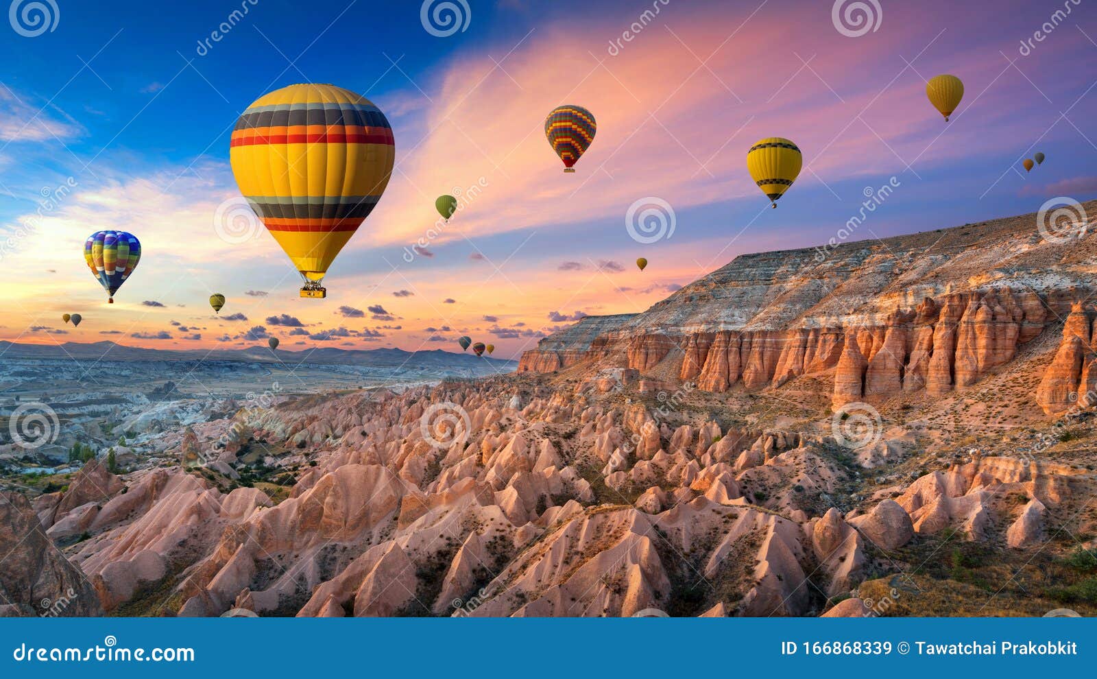 hot air balloons and red valley at sunset in goreme, cappadocia in turkey.
