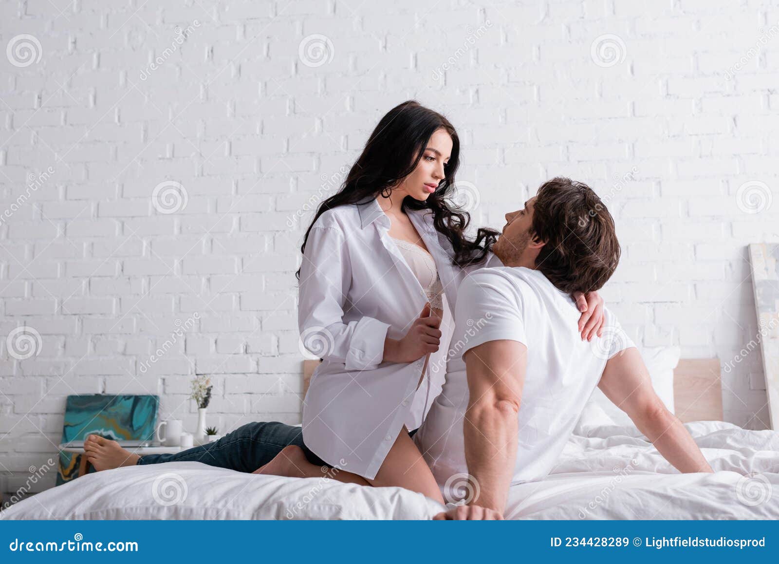 Hot Brunette Woman Seducing Young Man Stock Image