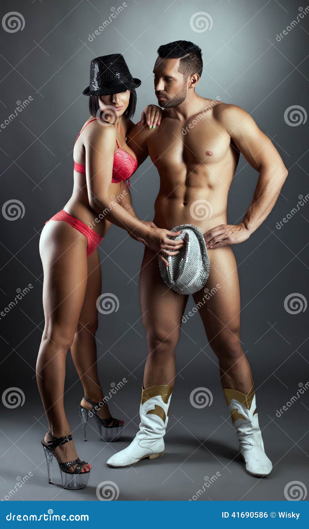 Hot Busty Woman Covers Her Naked Lover with Hat Stock Photo photo