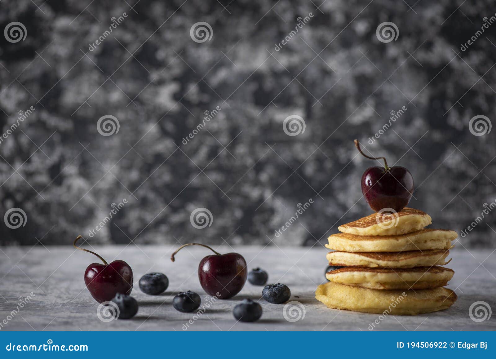 hot cakes with strawberries and cherries seen from close up