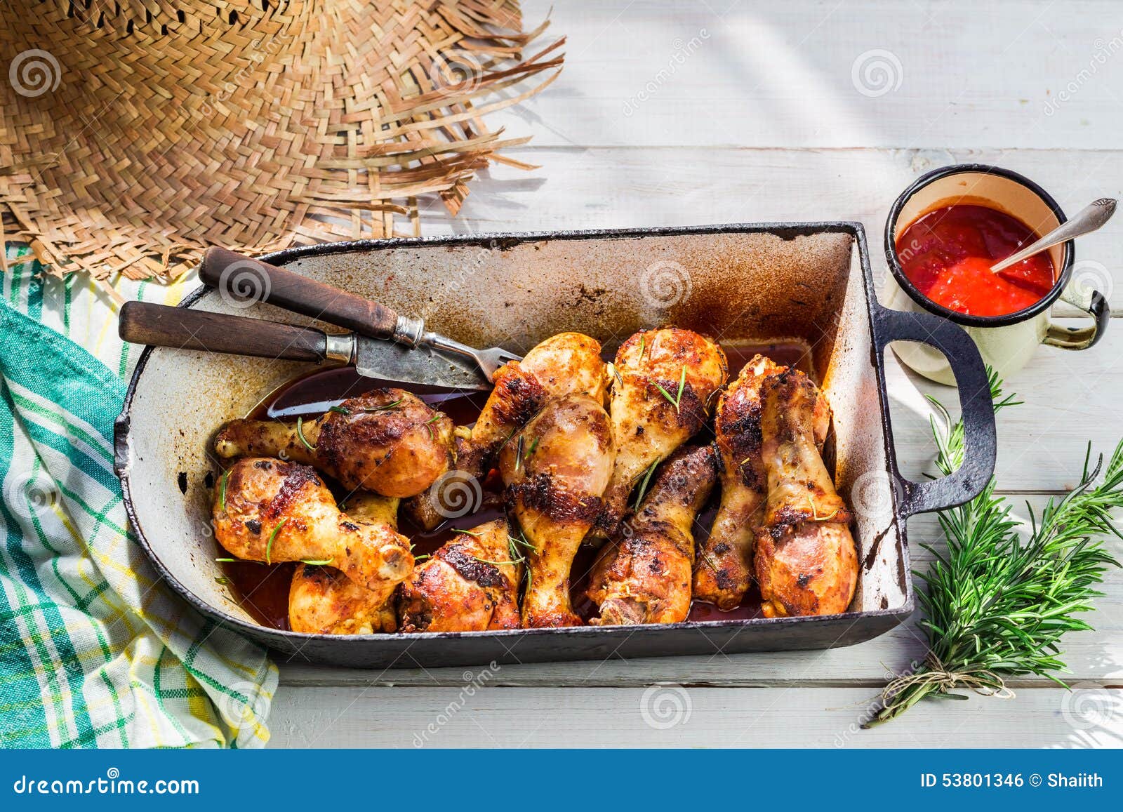 Hot Chicken Legs with Herbs and Sauce in Rustic Kitchen Stock Photo