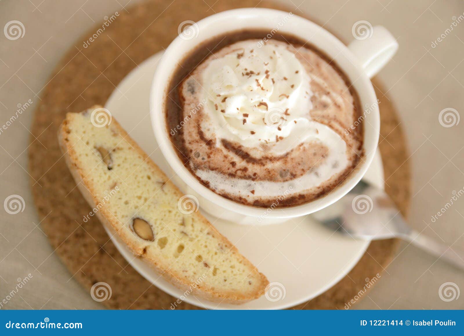 Top view of a hot chocolate with biscotti and spoon