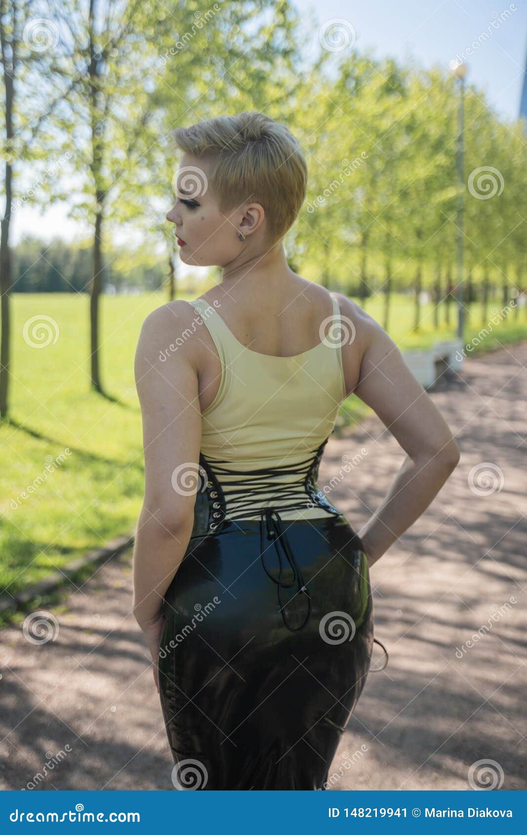 Hot Curvy Woman with Short Hair and Big Boobs Wearing Latex Kinky Secretary  Dress with Feitsh Corset and Walking in the Park Alone Stock Image - Image  of fetish, fetisch: 148219941