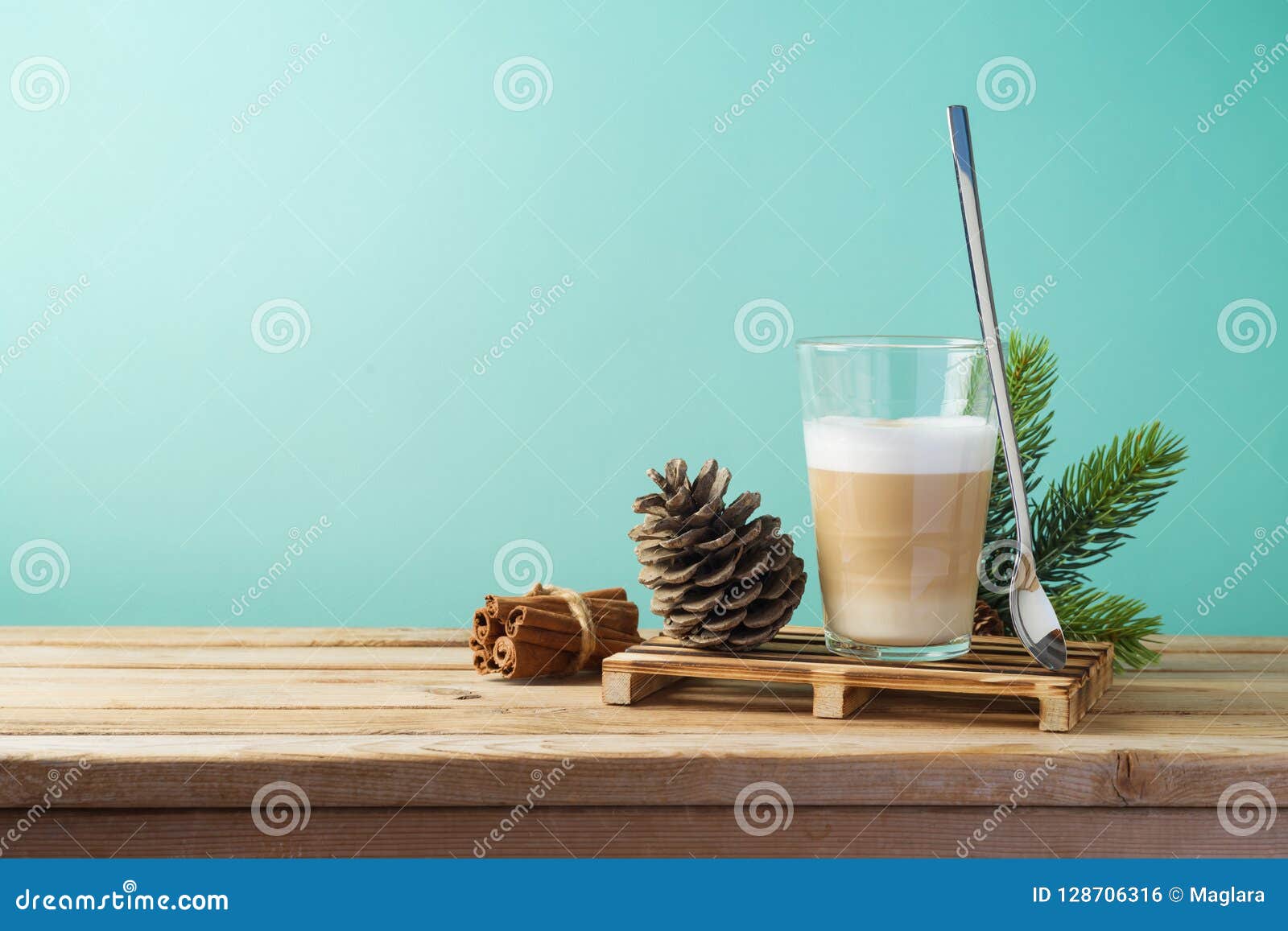 hot latte macchiato coffee cup on wooden table. christmas menu