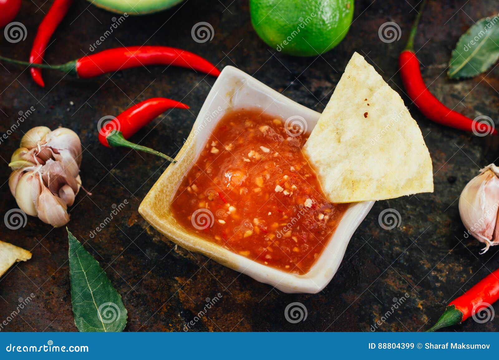 Hot Mexican Salsa Whith the Nacho Chips Surrounded by Ingredients