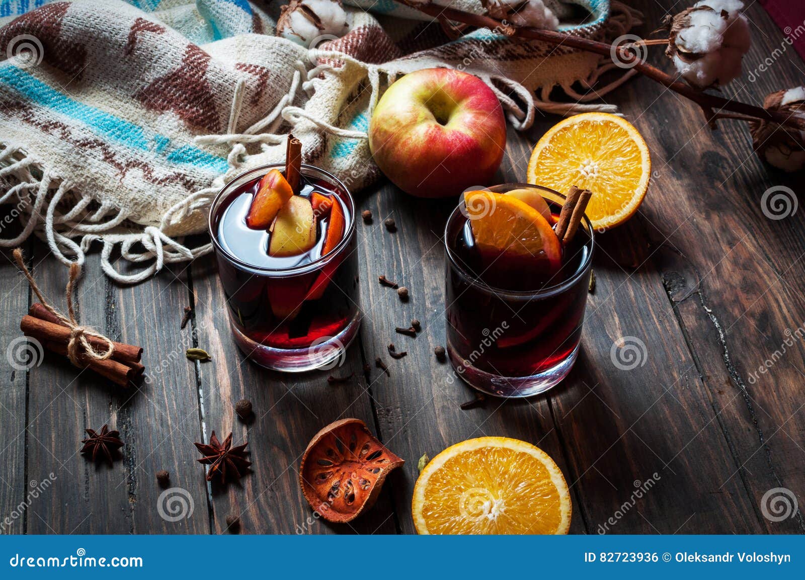 Hot Mulled Wine with Spices, Apple and Orange on Wood Stock Photo