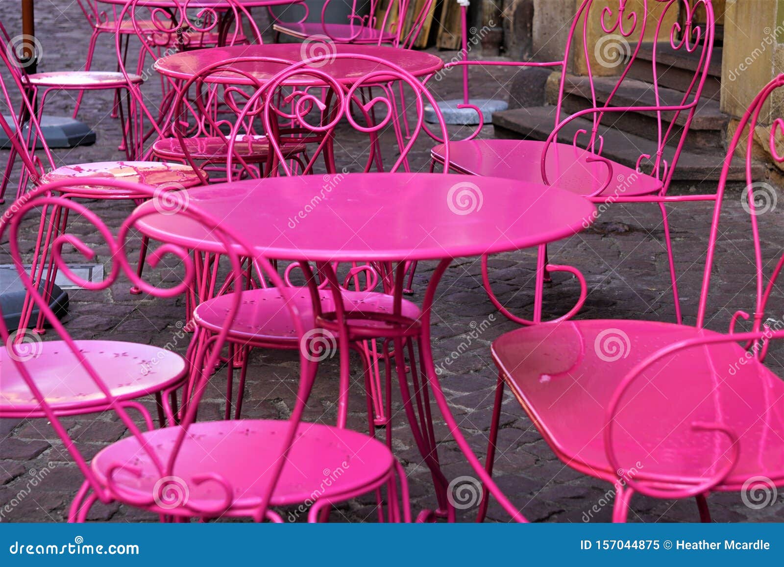 Hot Pink Metal Tables And Chairs Out On Brick Sidewalk Stock Image