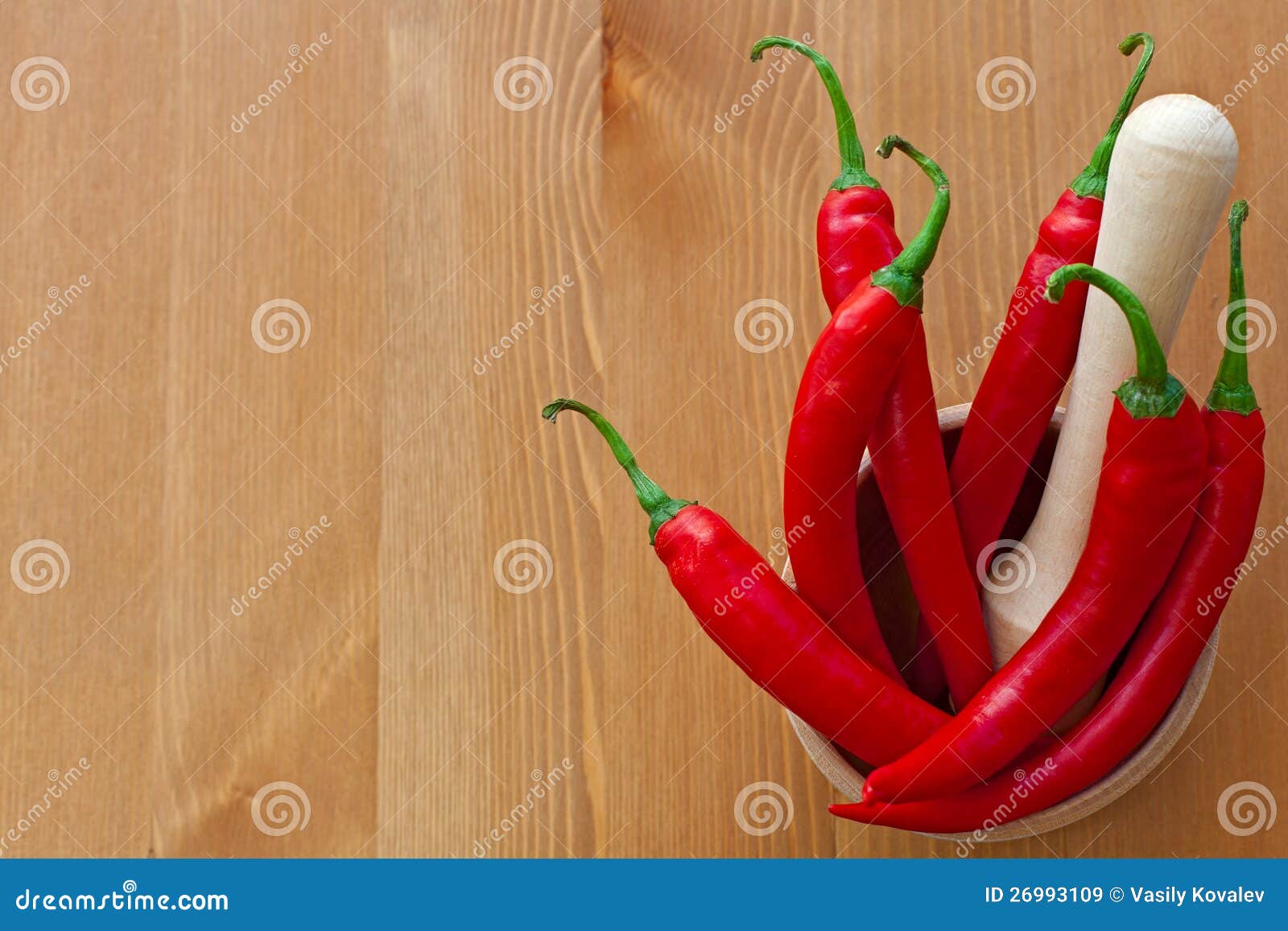 hot red peppers and wooden pounder
