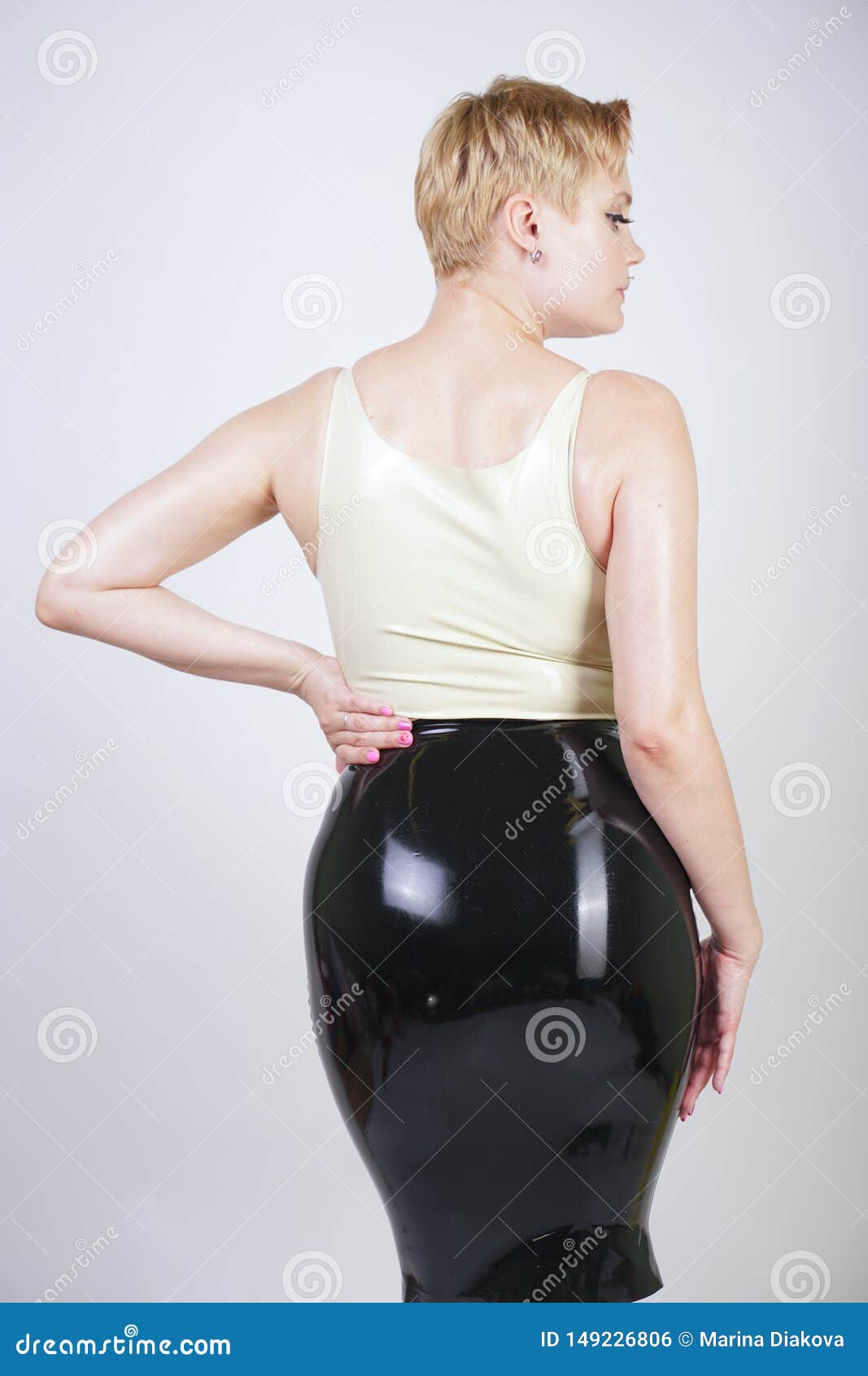Hot Short Hair Blonde Girl with Curvy Body Wearing Latex Rubber Dress on  White Studio Background Stock Photo - Image of caucasian, heels: 149226806