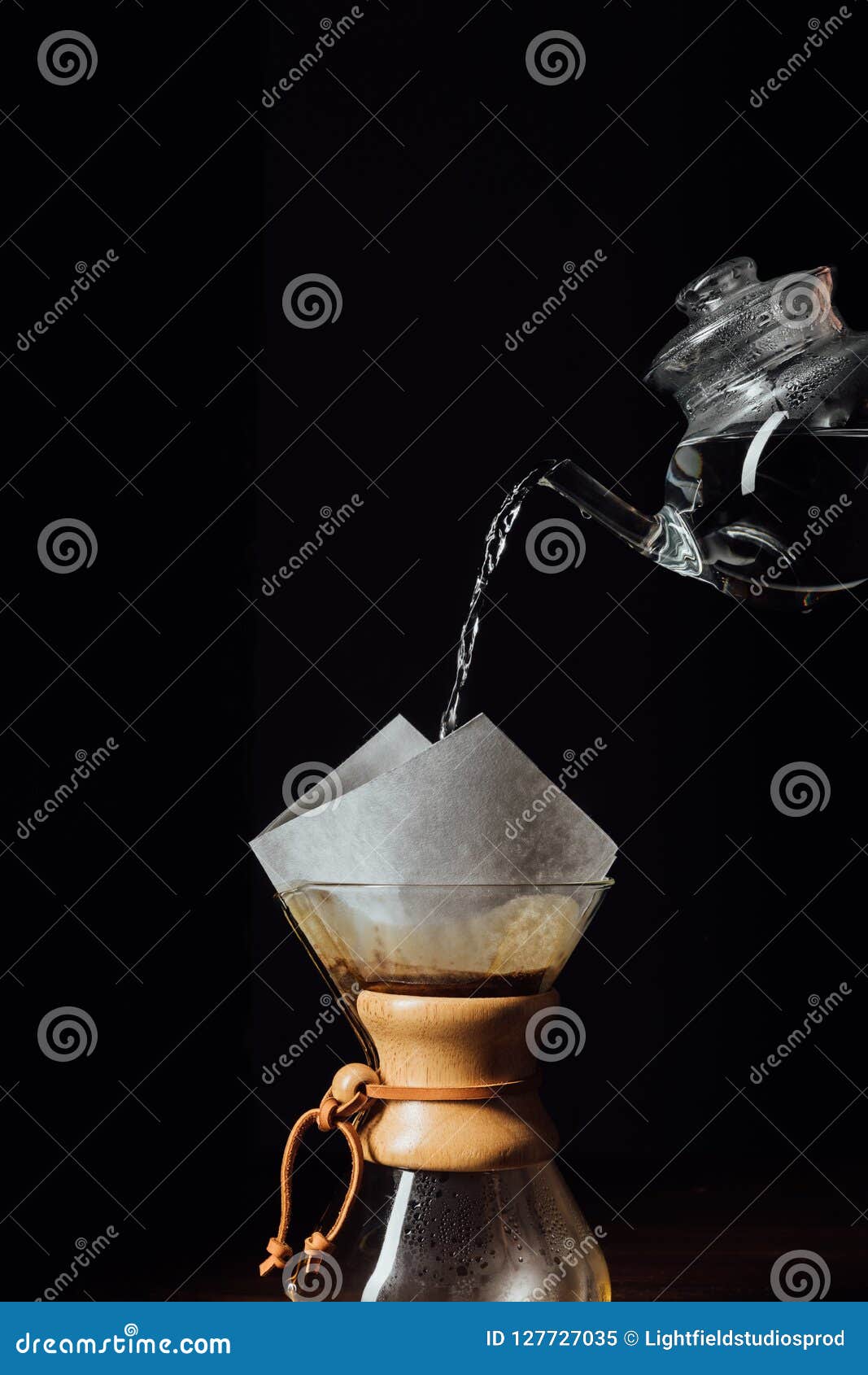 Hot Water Pouring into Chemex with Filter Cone, Isolated on Black Stock