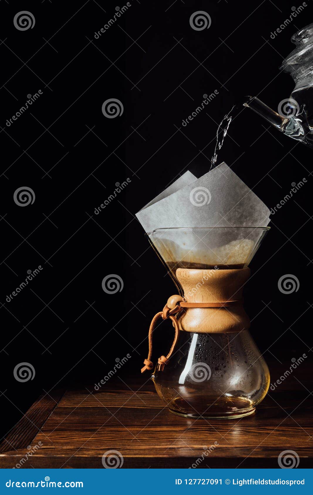 Hot Water Pouring into Chemex with Filter Cone on Wooden Table Stock
