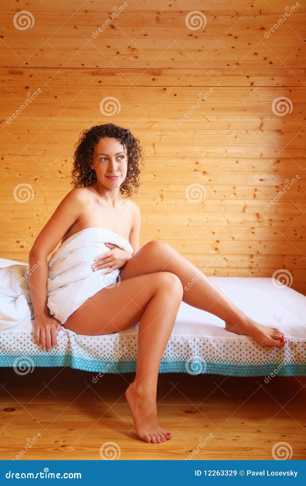 Hot Woman Sitting On Bed In Cosy Room Stock Image - Image 