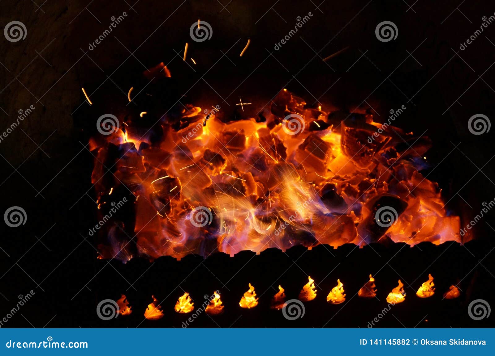 Hot Wood Coals Burn with Bright Flame in Iron Brazier Stock Photo