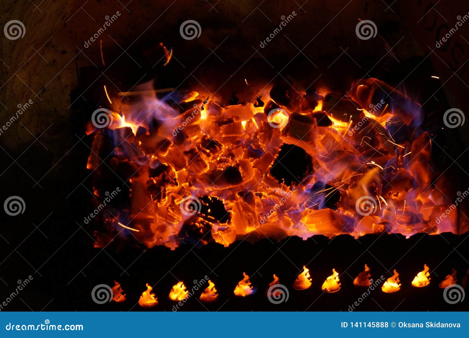 Hot Wood Coals Burn with Bright Flame in Iron Brazier Stock Photo