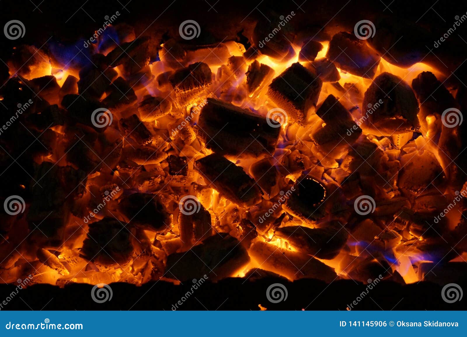 Hot Wood Coals Burn with Bright Flame in Iron Brazier Stock Photo