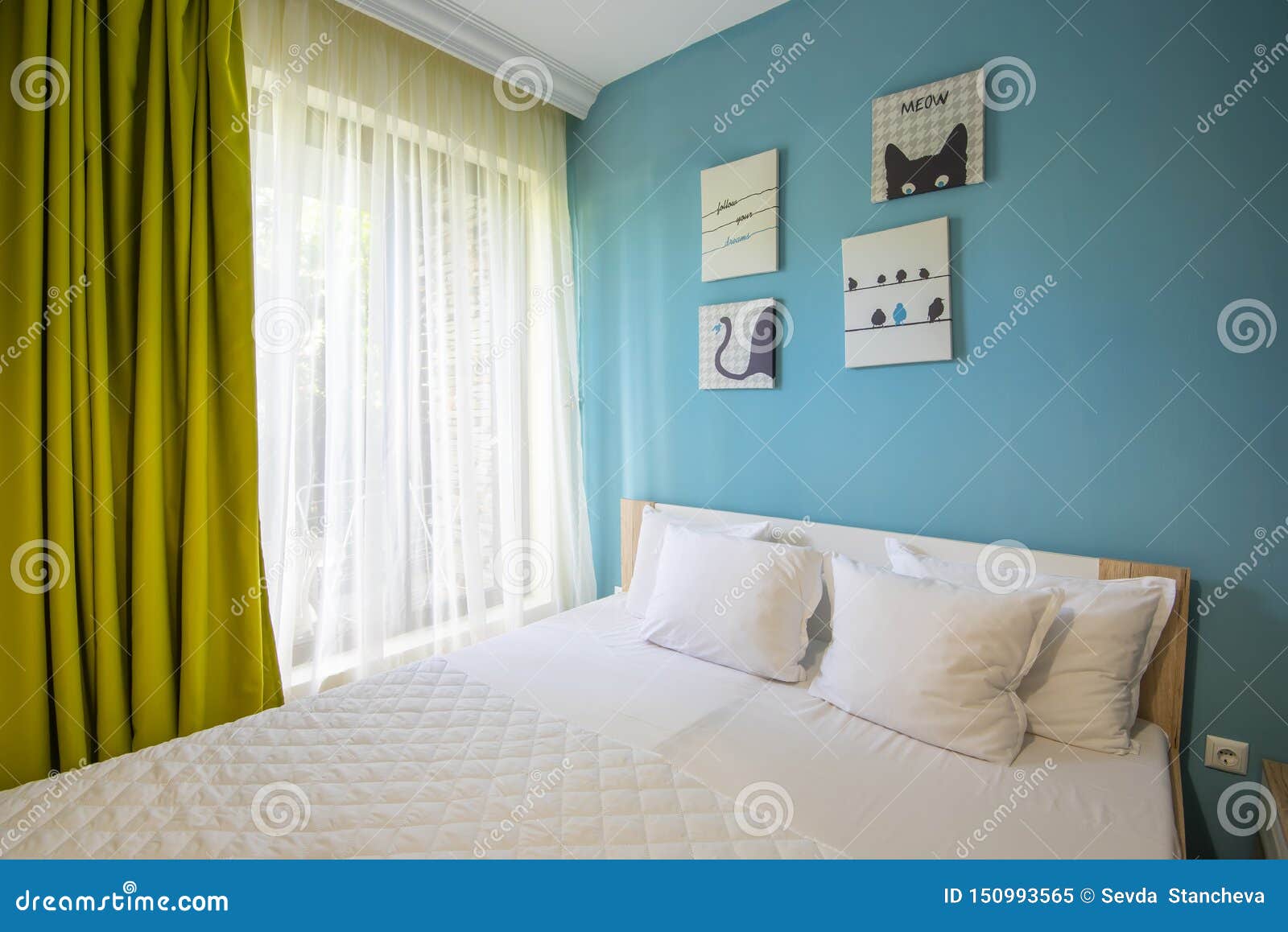 Hotel Bedroom With Blue Walls White Sheers Pillowcases And