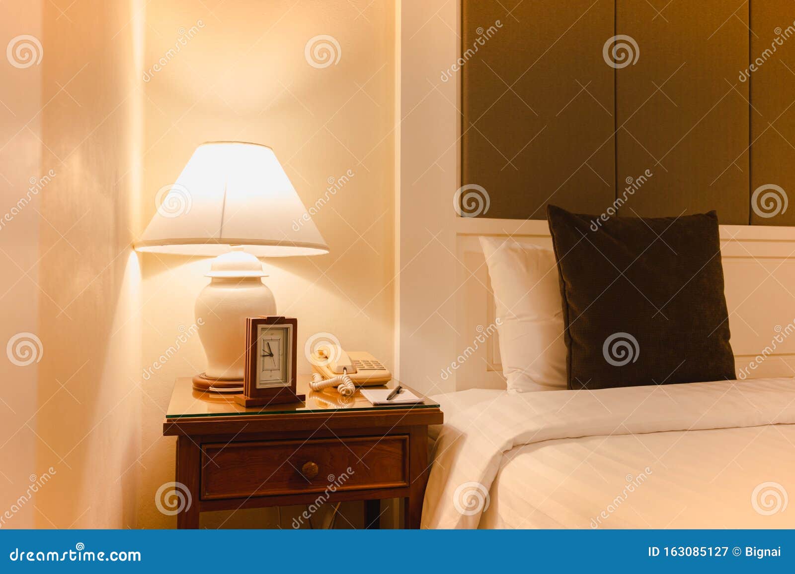 Hotel Bedroom with Reading Lamp and Clock with Telephone in Modern