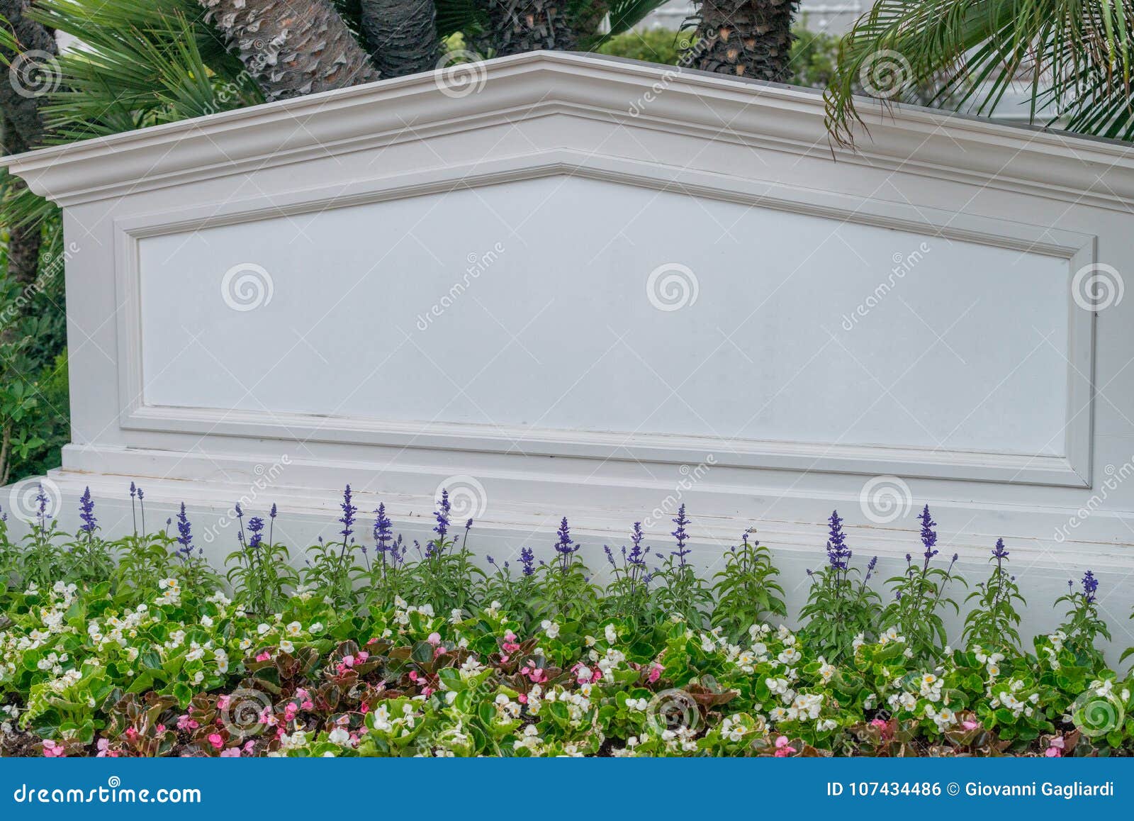 hotel entrance sourrounded by flowers, empty with name to fill