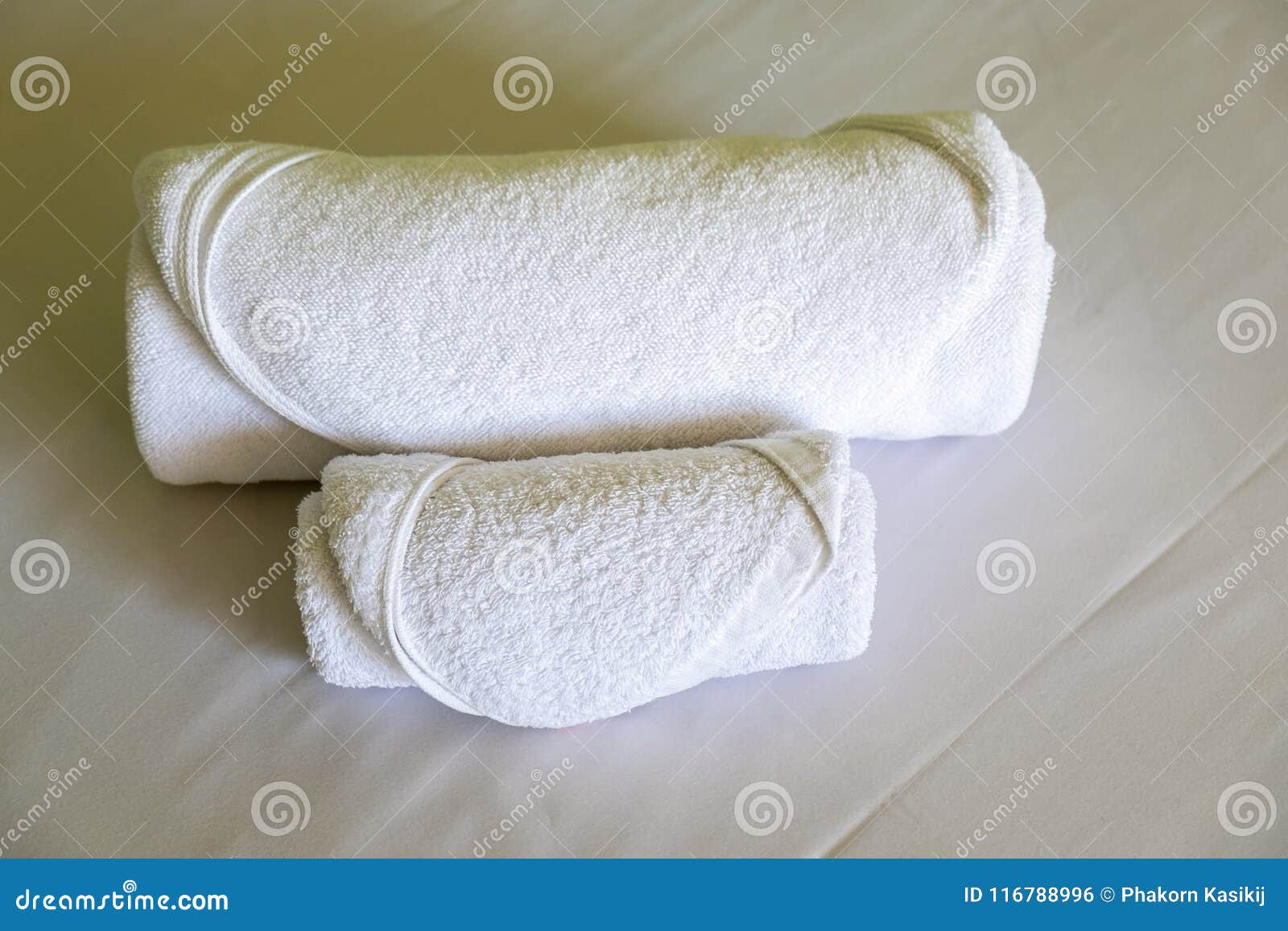 Hotel Towels Roll on the White Bed in the Bedroom Stock Photo Image