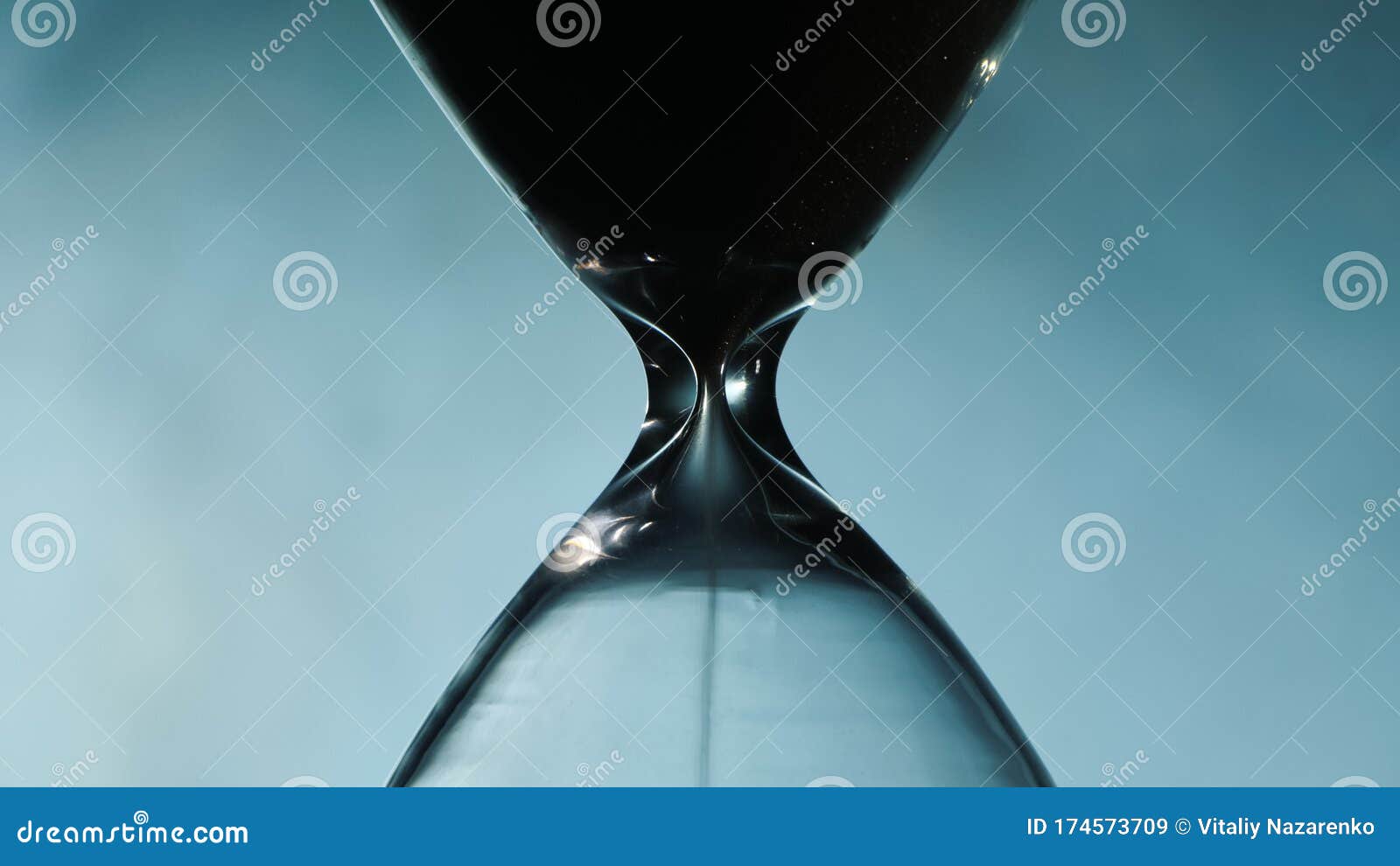 Hourglass Against the Fog Illuminated by the Spotlight Stock Image