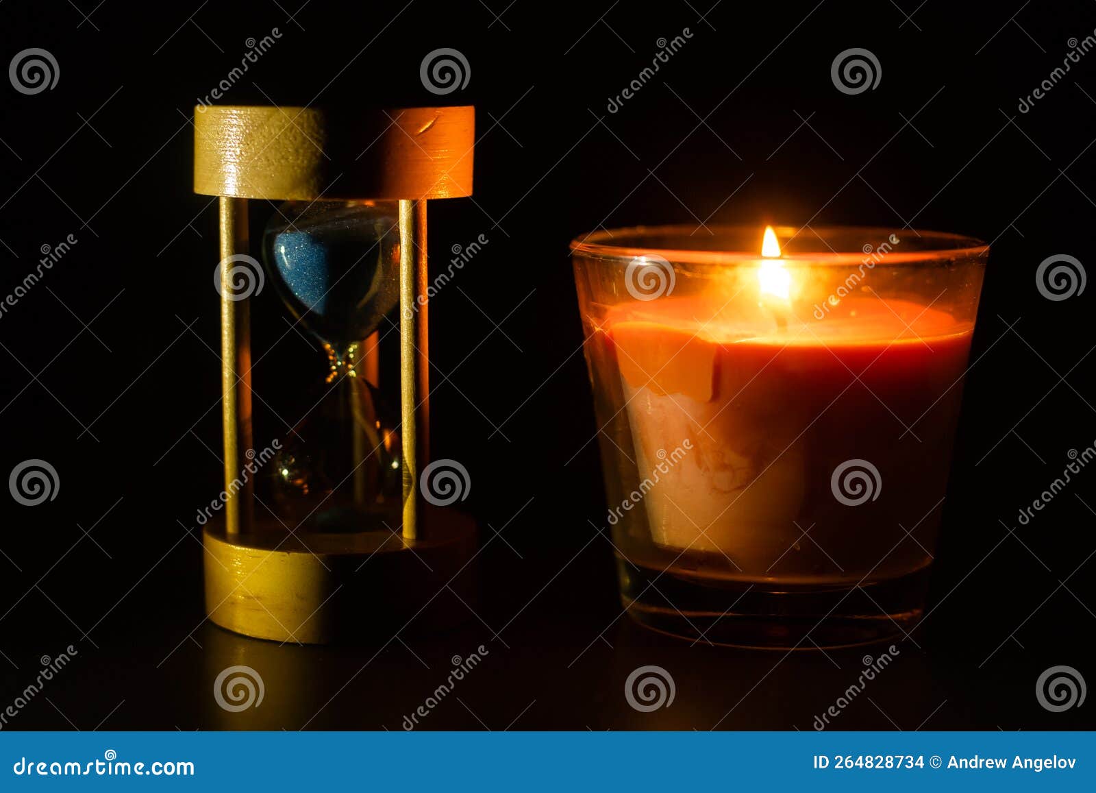An Hourglass Under the Candle Light. Stock Photo Image of vintage